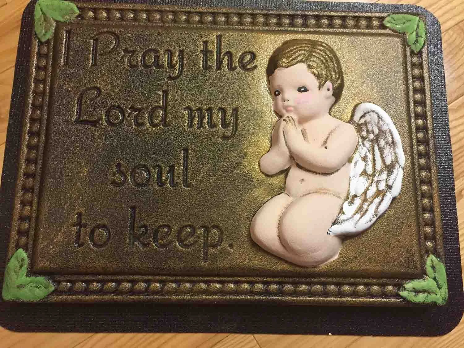 Cherub praying on a memorial plaque mold.jpg