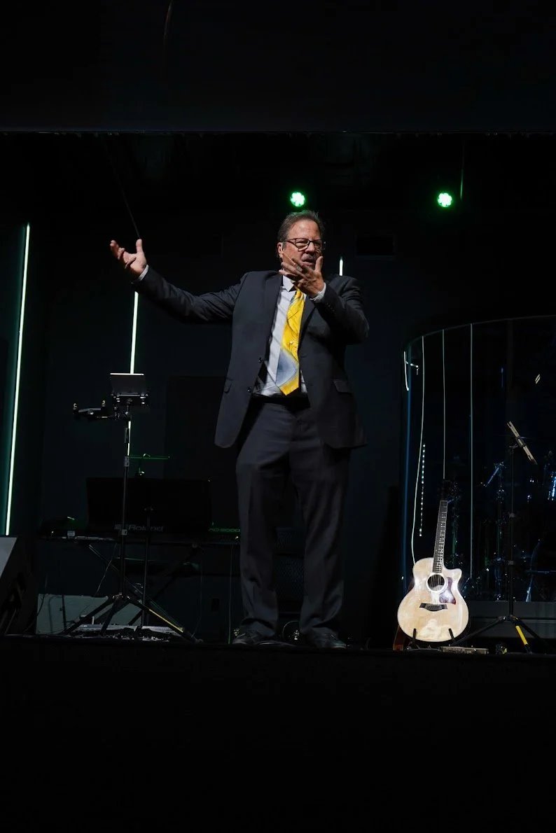 Pastor John Jones is speaking on stage.