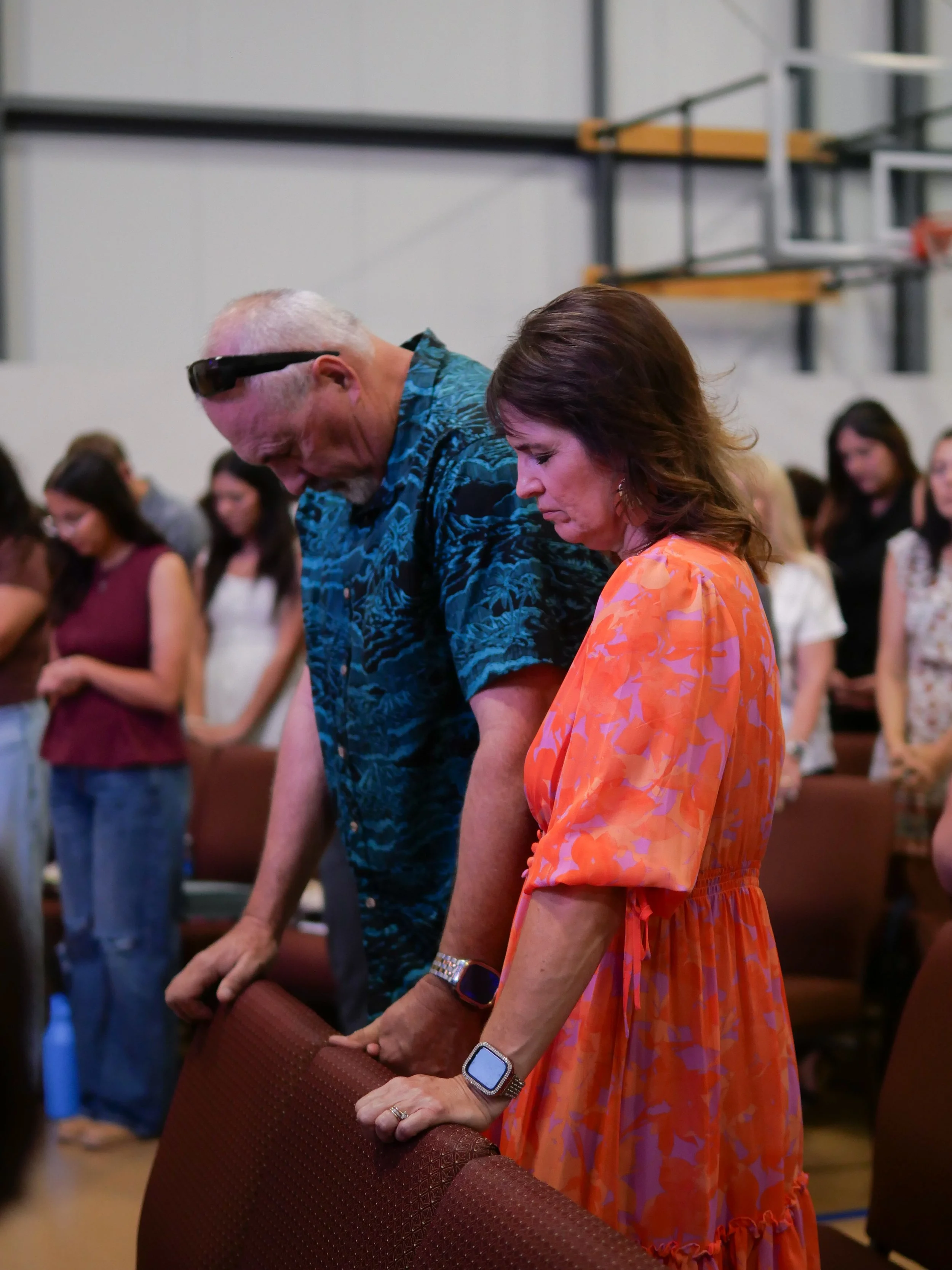 A man and woman praying together.