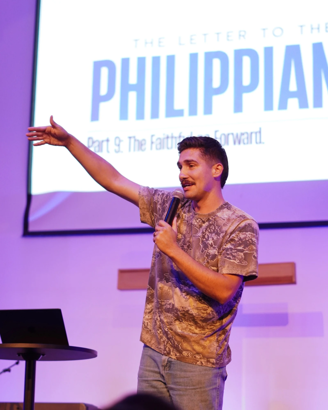 A man electric guitar on stage during worship.