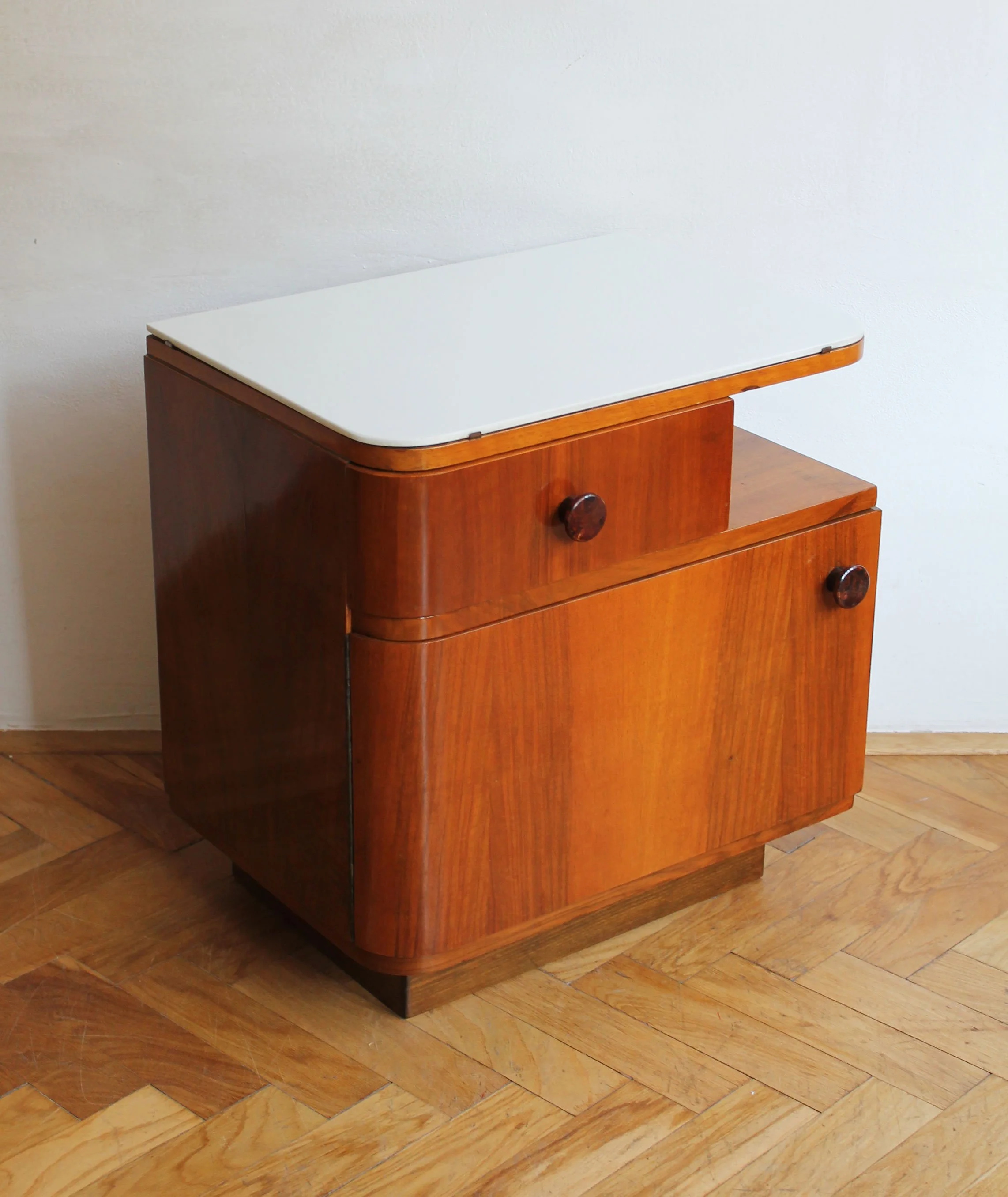 detail of white opaxite glass top on vintage bedside table.jpg