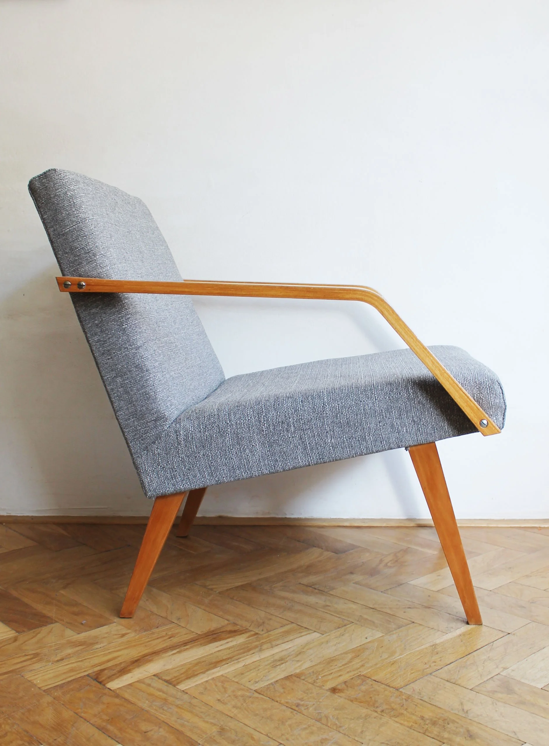 detail of curved wooden armrests mid century chair.jpg