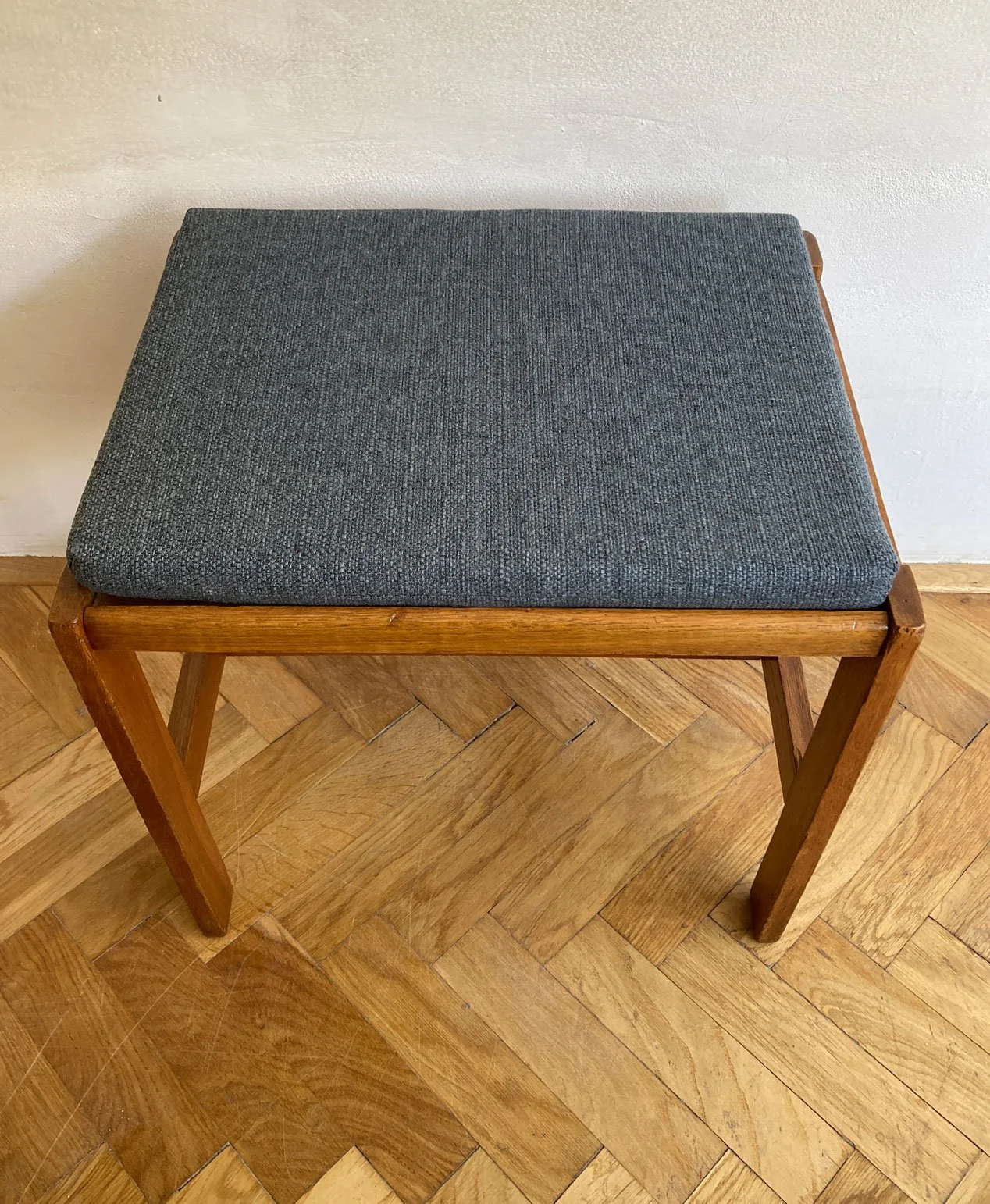 Side view of vintage Czech wooden stool with upholstered cushionjpg