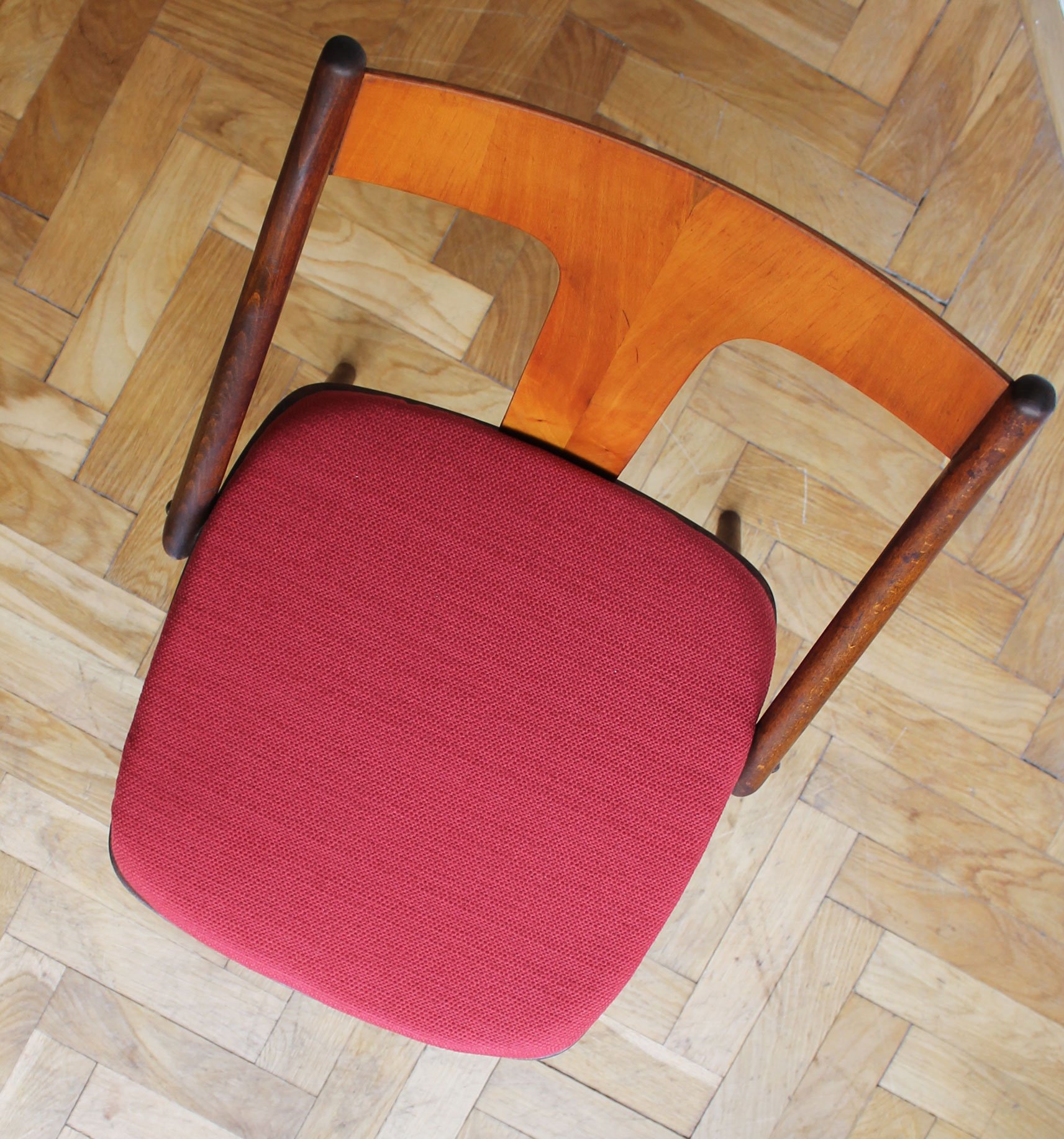 Dark stained wooden dining chairs with curved back support.jpg
