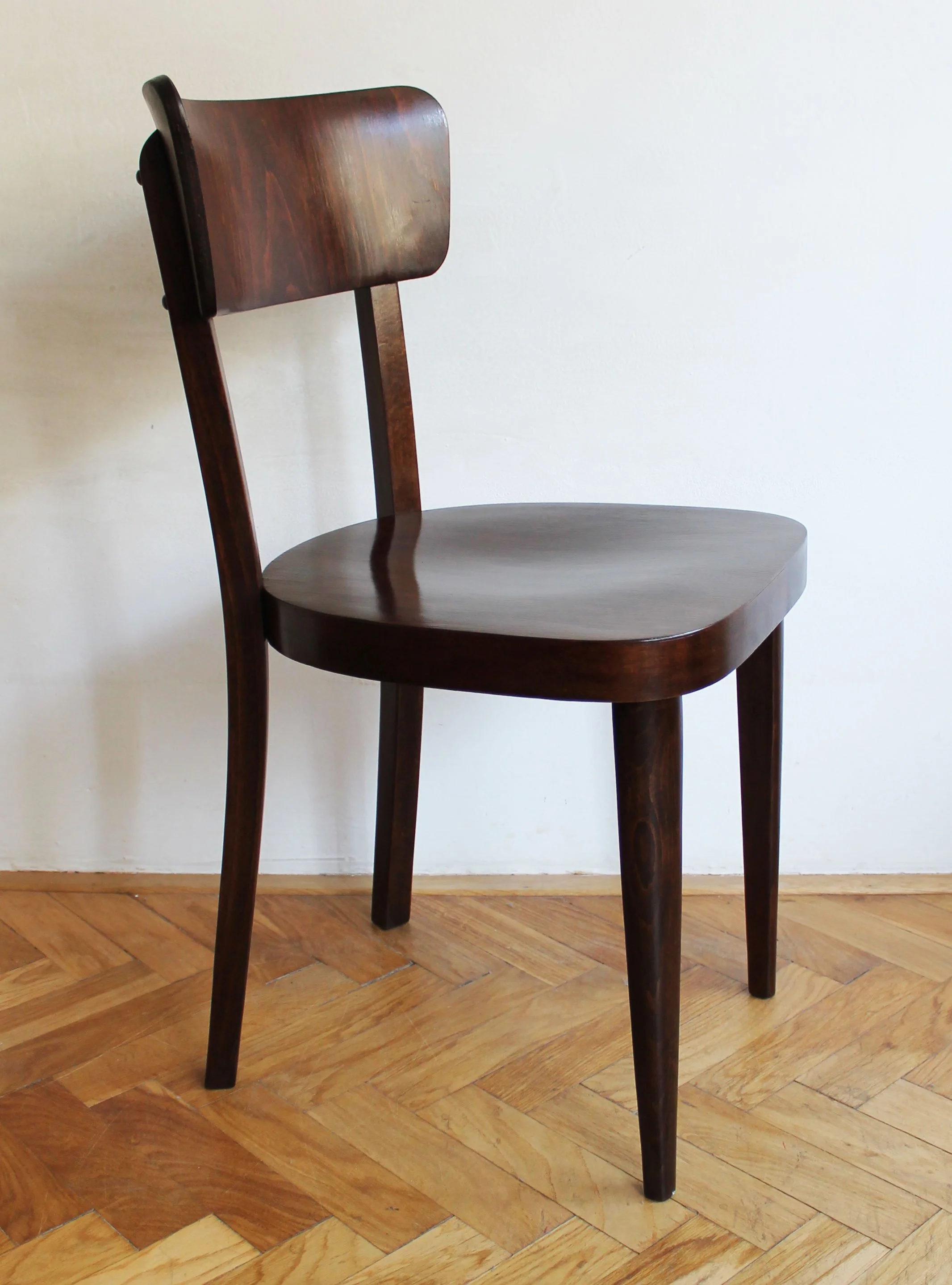 Modernist Thonet wooden chair with curved seat and backrest.jpg