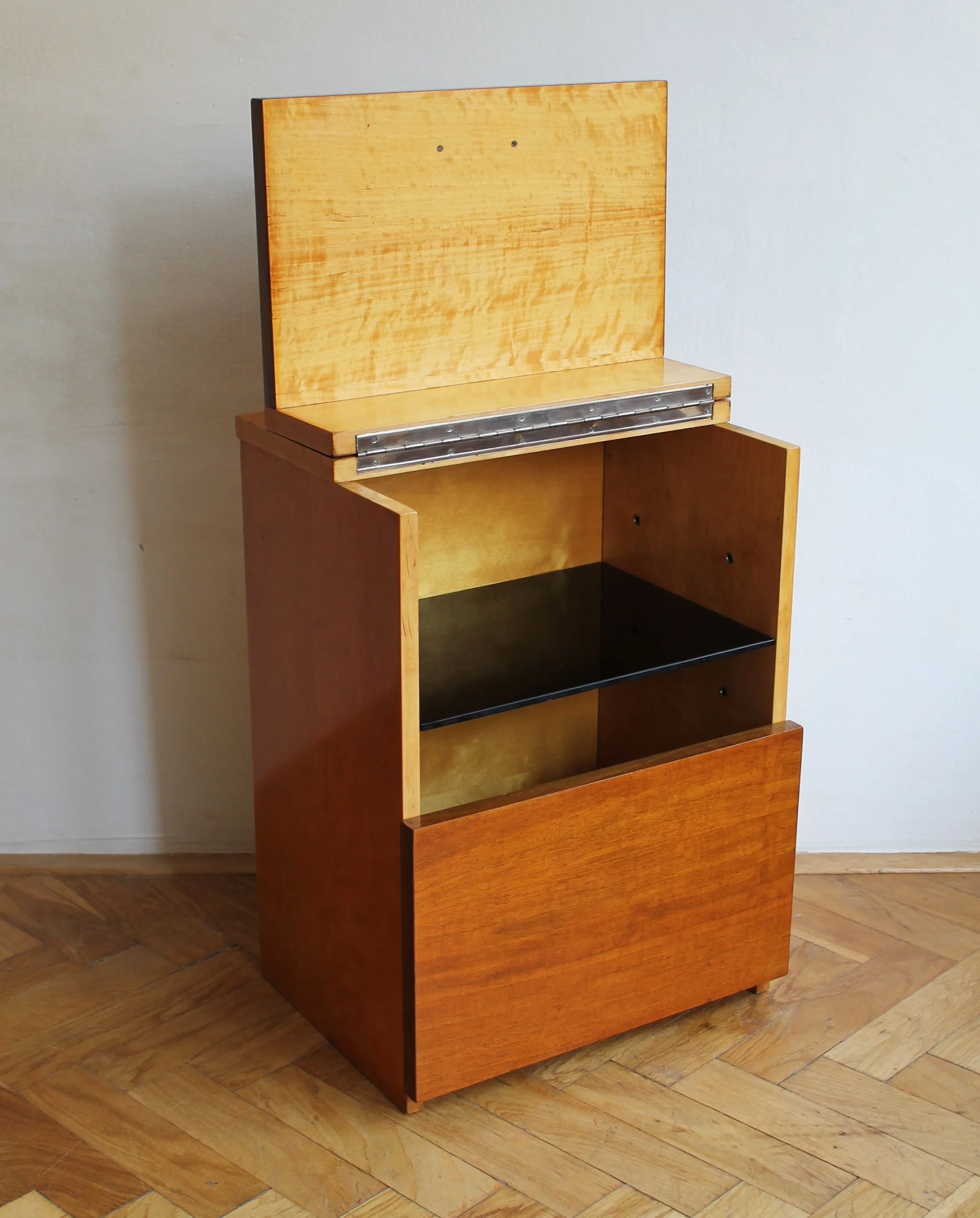 Cabinet with top lid open, revealing interior storage space