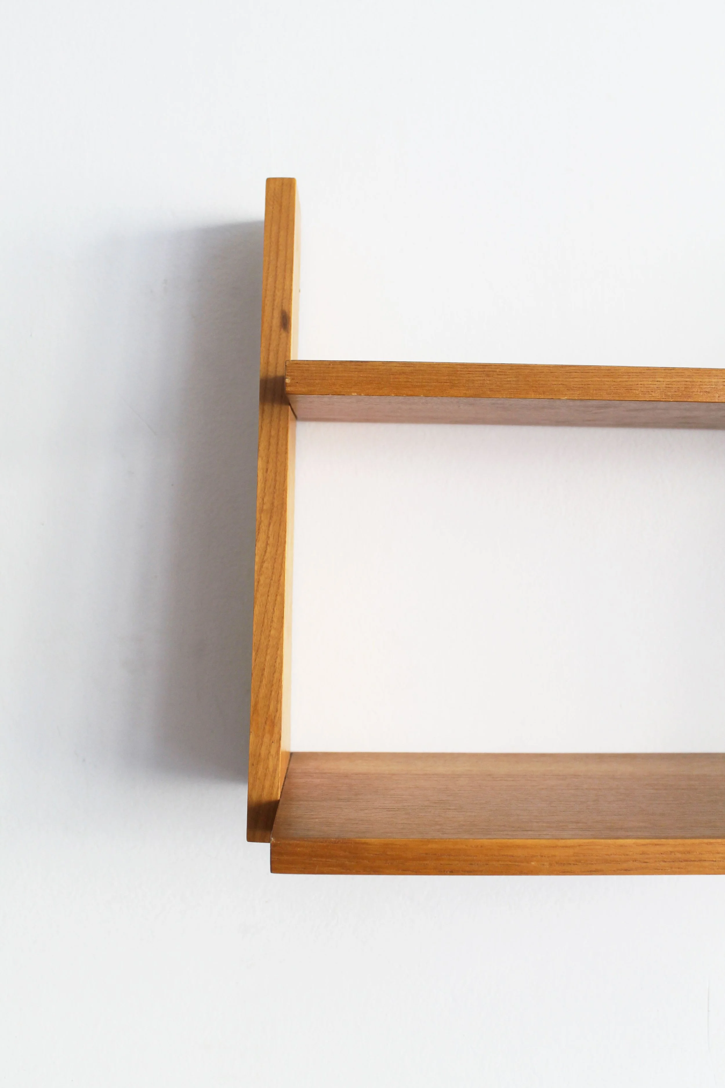 Close-up of 1960s Czechoslovak wall shelf showing angled beech support and shelf joint