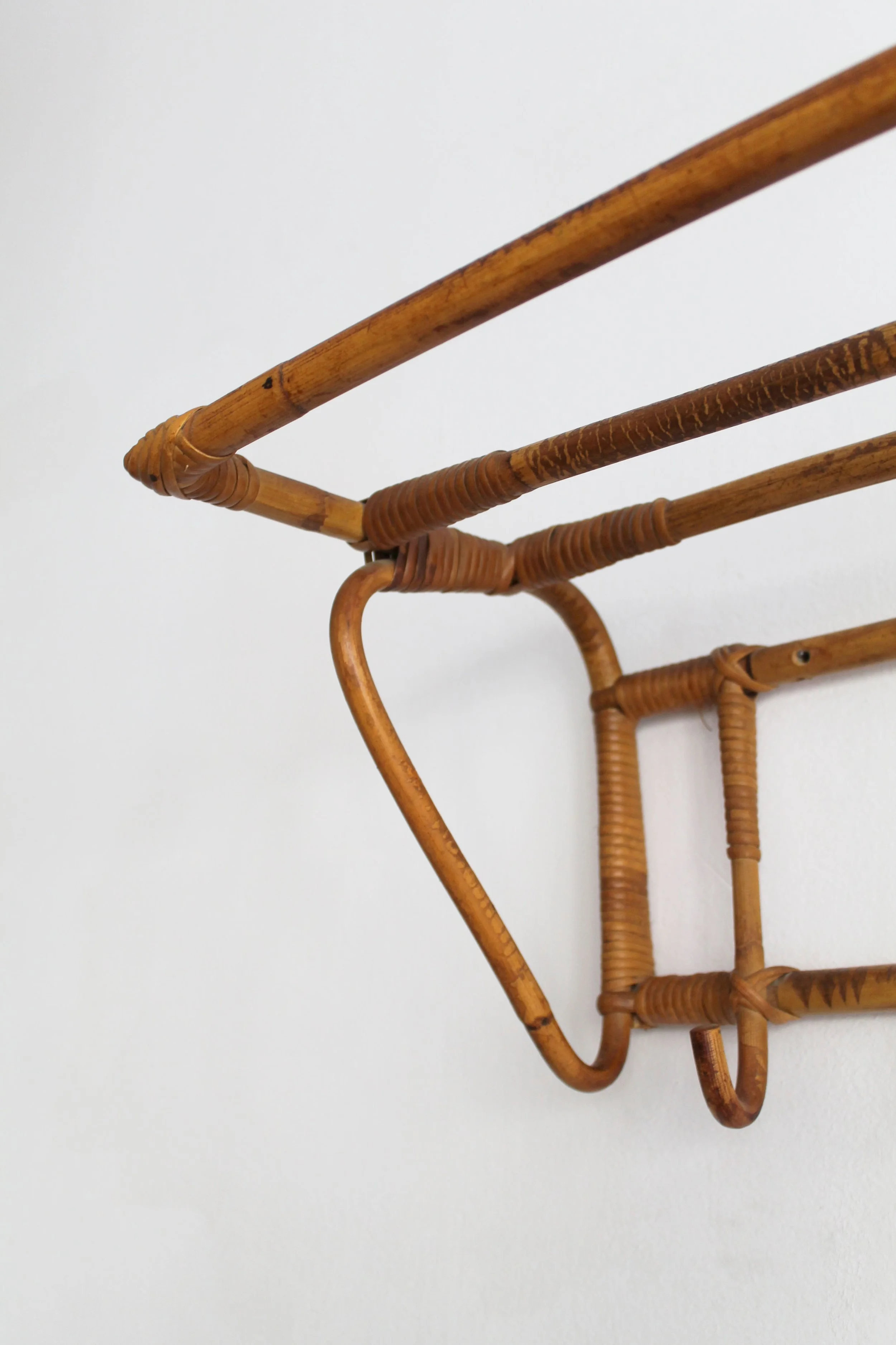 Bent cane hooks and decorative wicker bindings on Czechoslovak wall coat rack.jpg