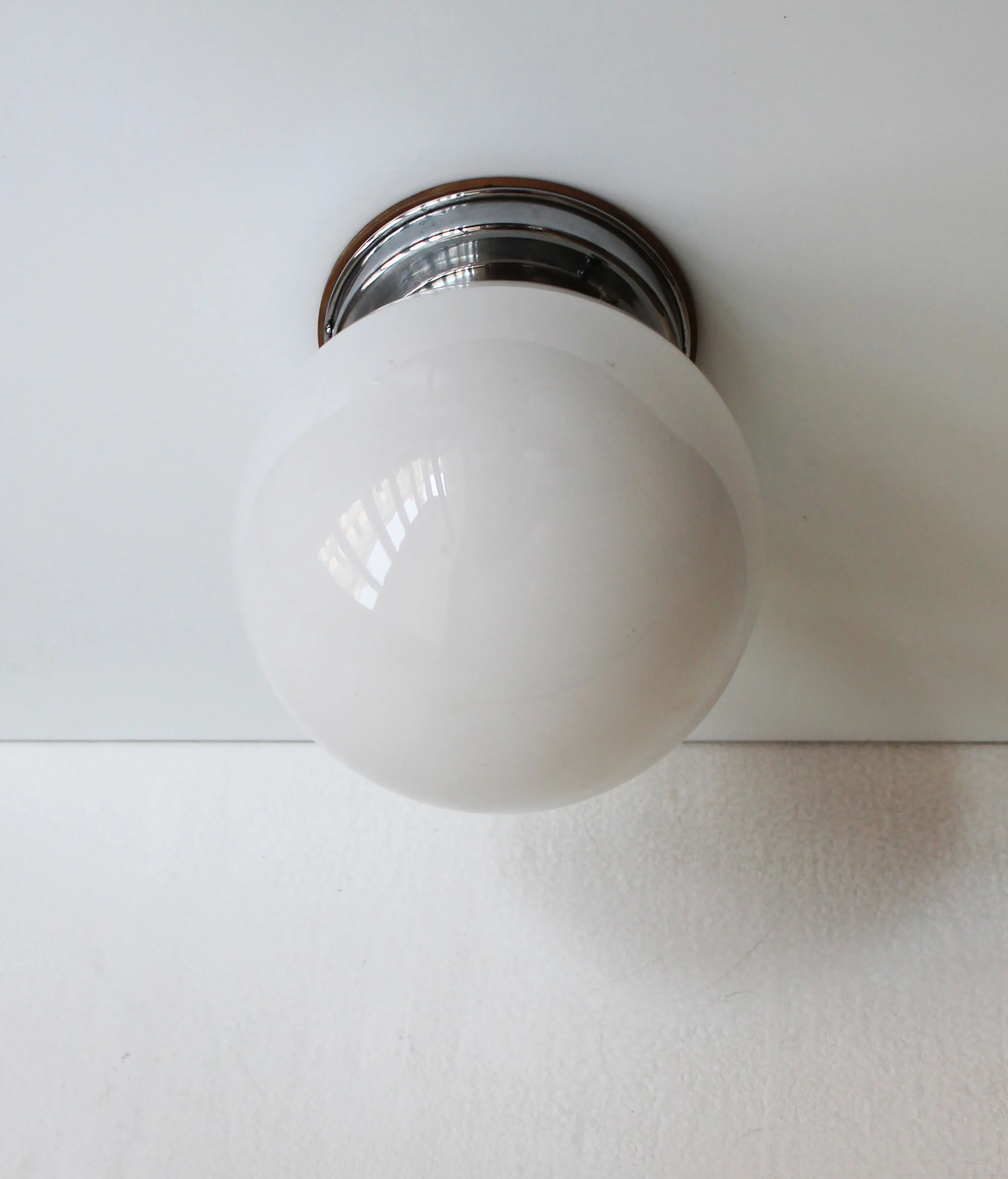 Side view of 1930s modernist wall lamp glass globe.jpg