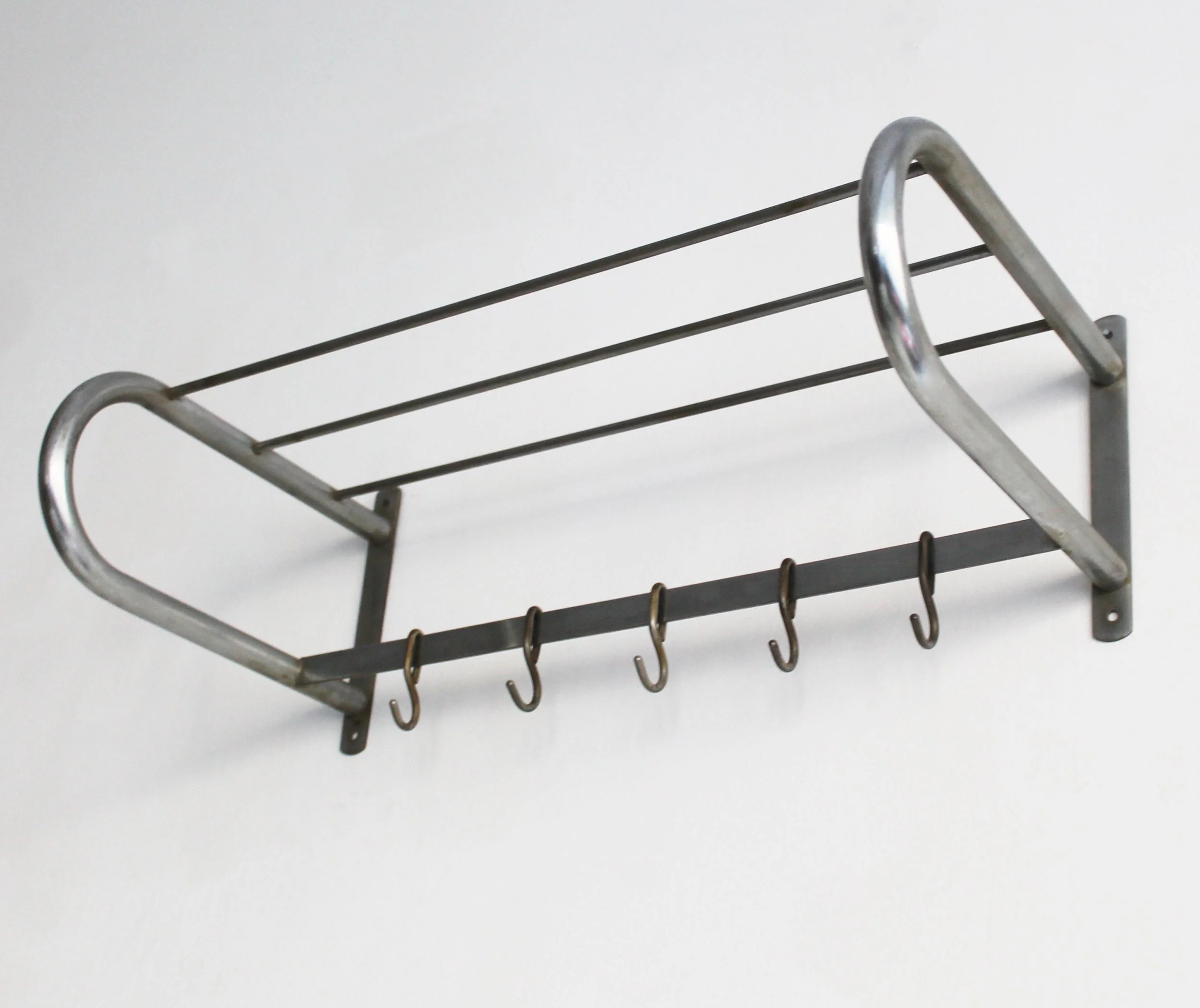 Functionalist chrome wall coat rack from the 1930s featuring elegant curved steel and flat bar hooks.jpg