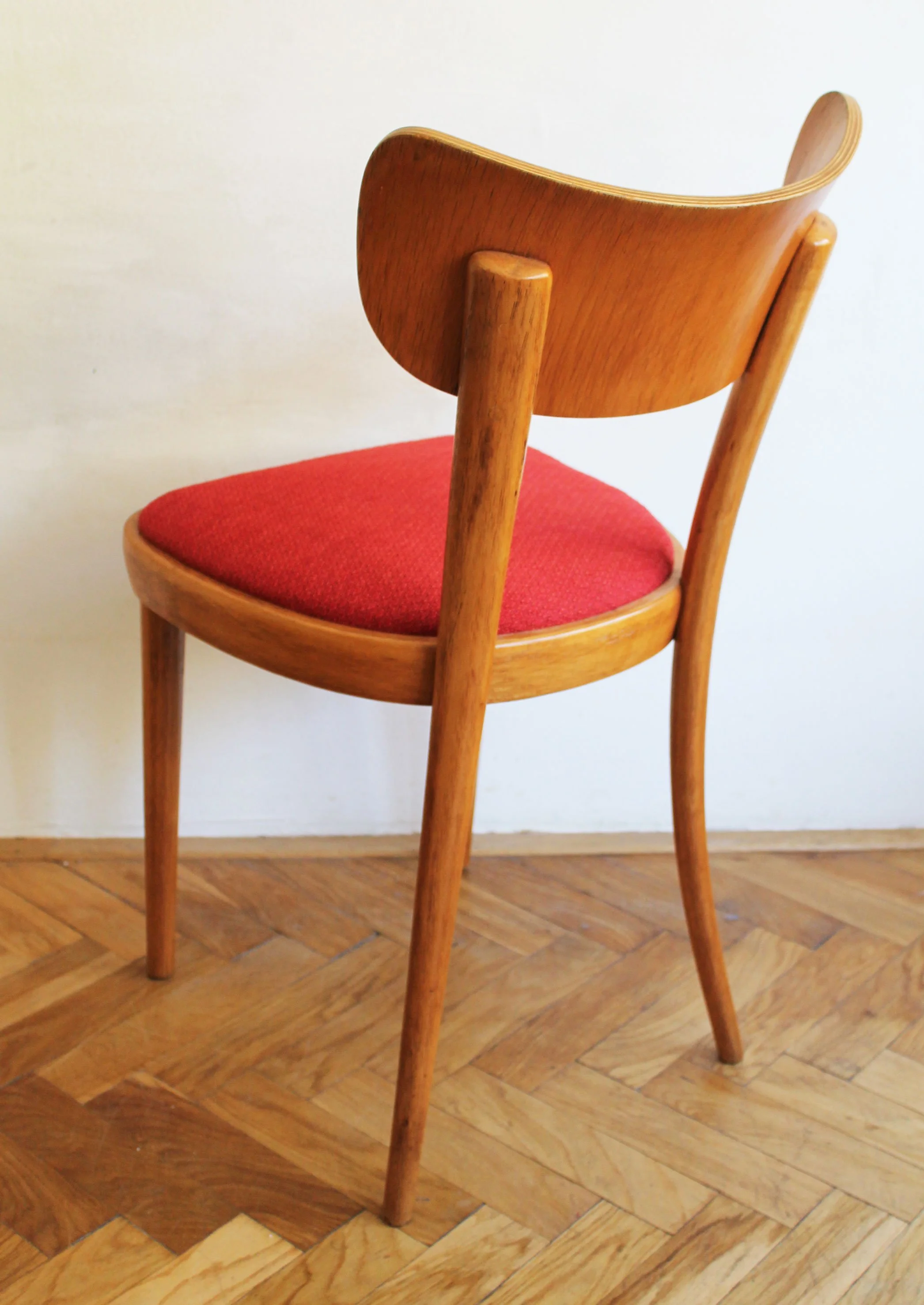 Bright red fabric upholstery on vintage Thonet seating.jpg