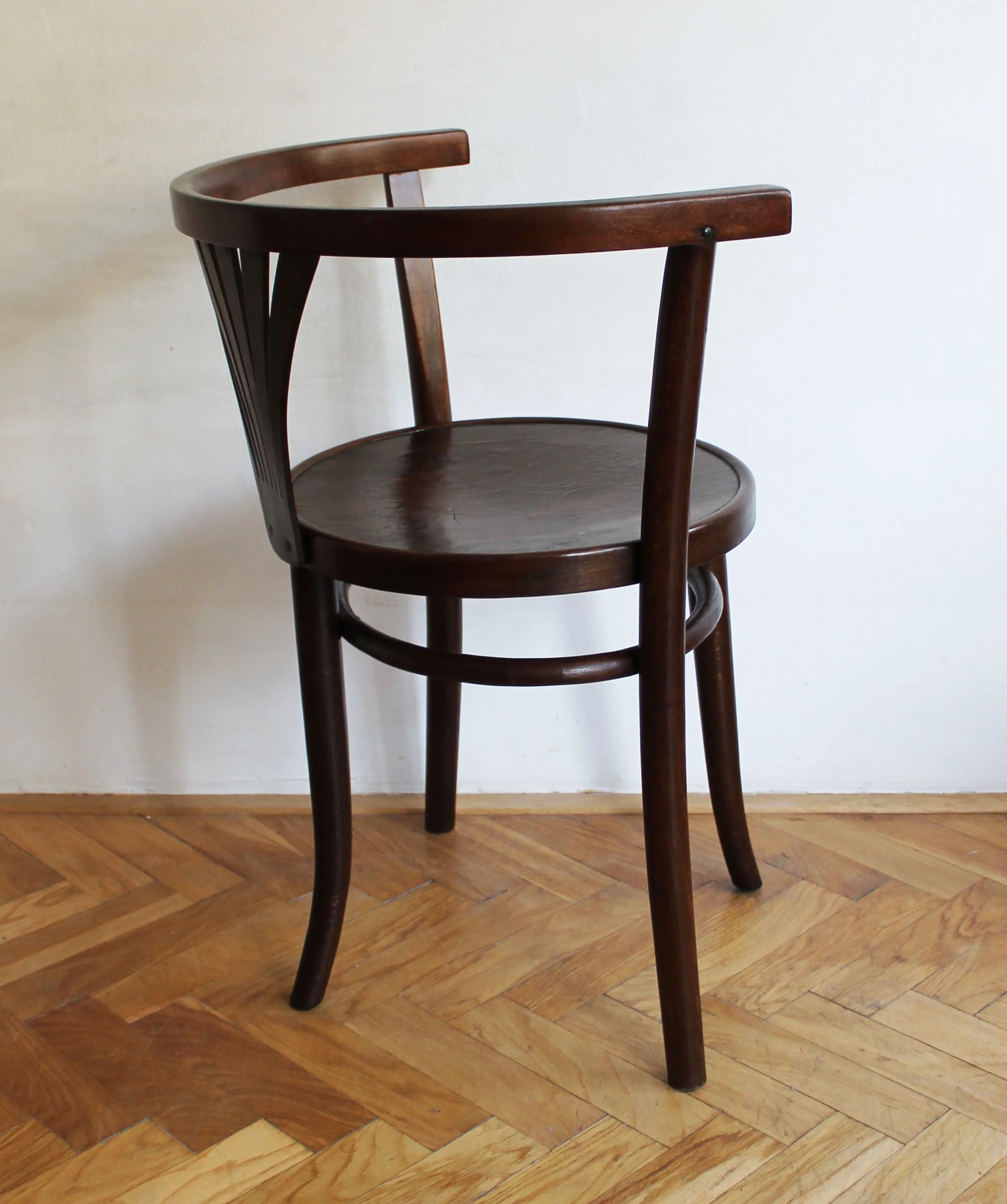 Antique Thonet-style chair with three-legged support and sculptural form.jpg