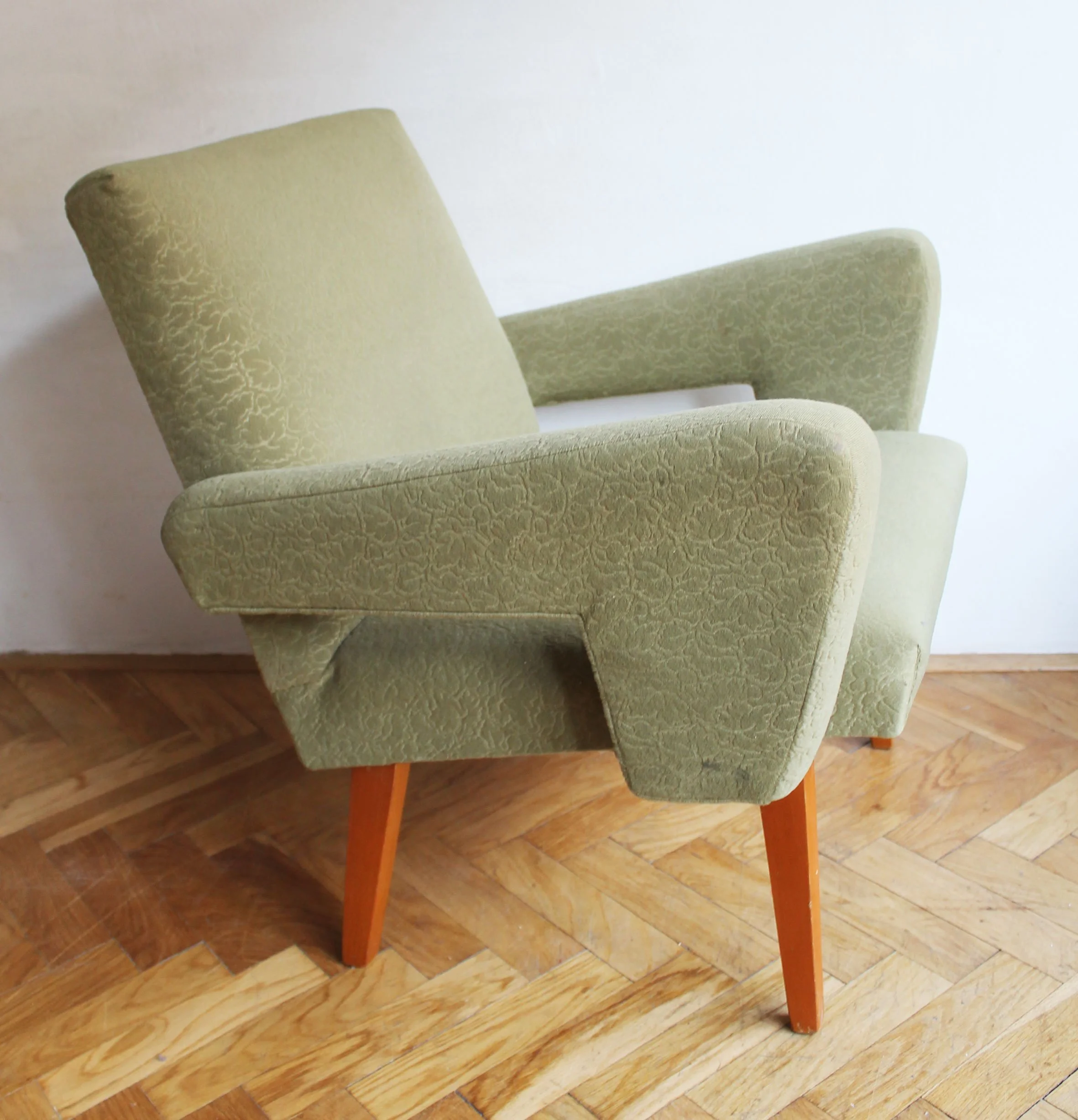 Sculptural wooden armrests on vintage Jitona armchair.jpg