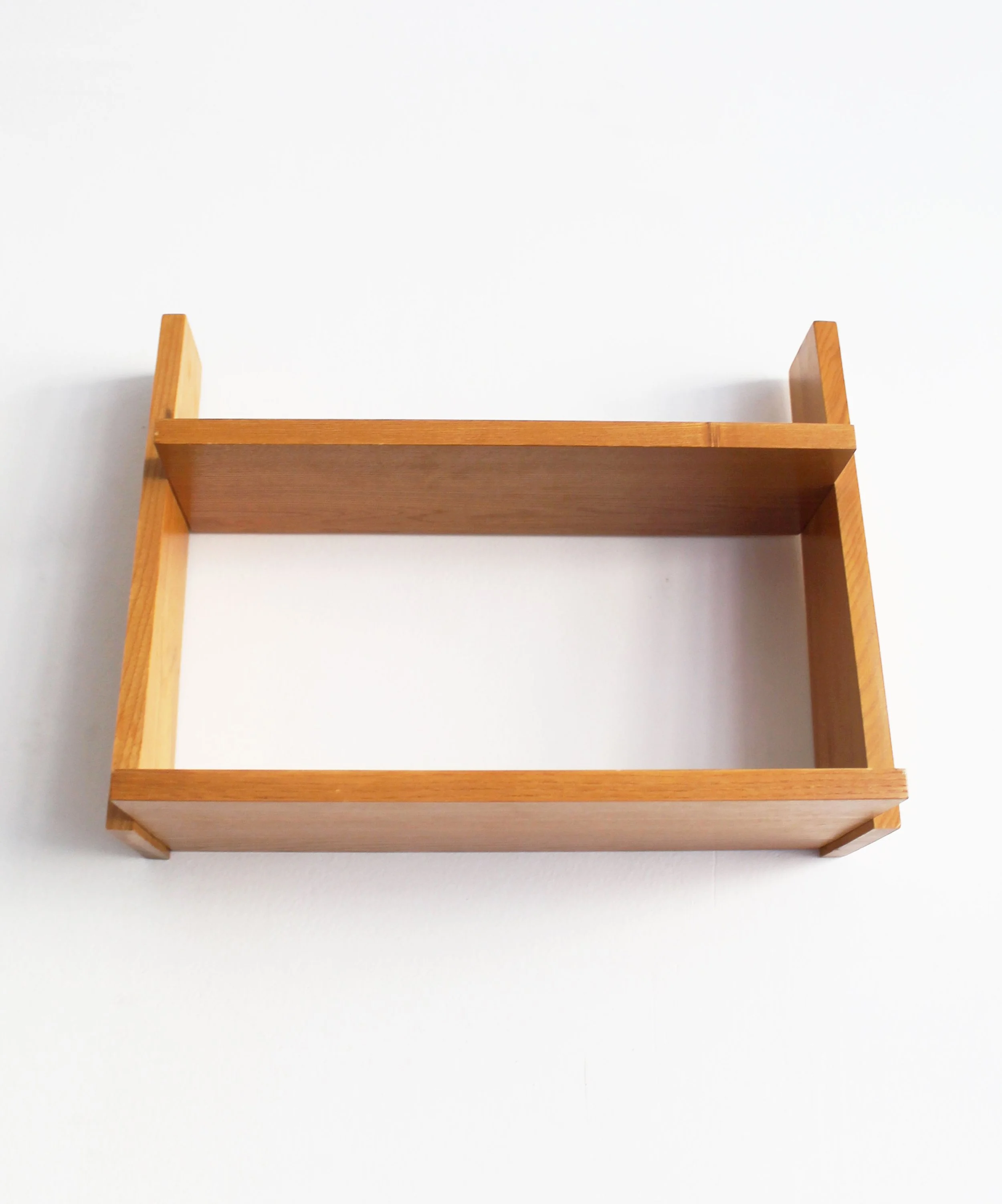 Low-angle view of vintage beech wall shelf showing shelves and projecting side supports