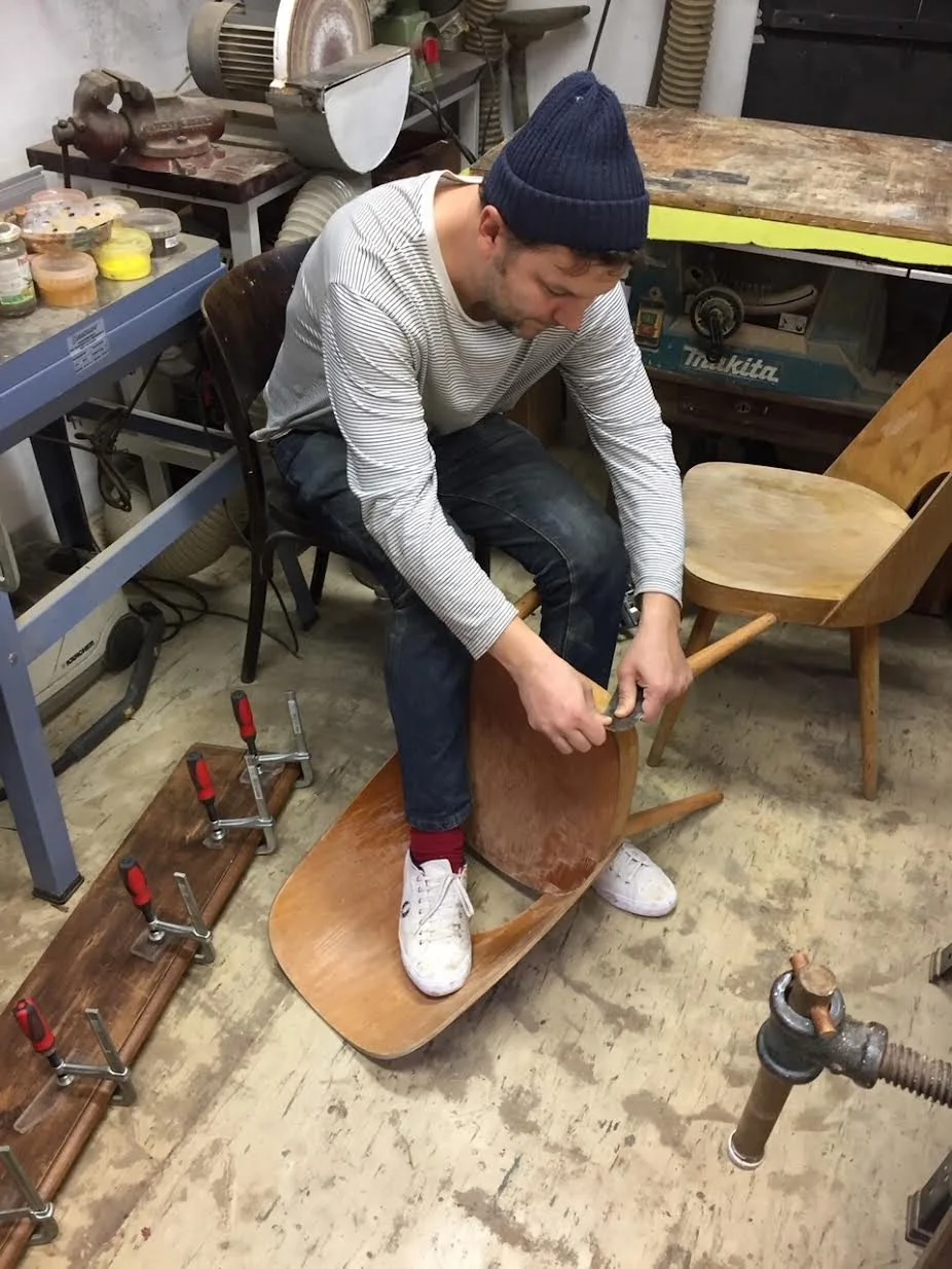 Martin Dohnálek restoring a vintage Czech chair at the By Barnabas furniture studio in Brno, Czech Republic.