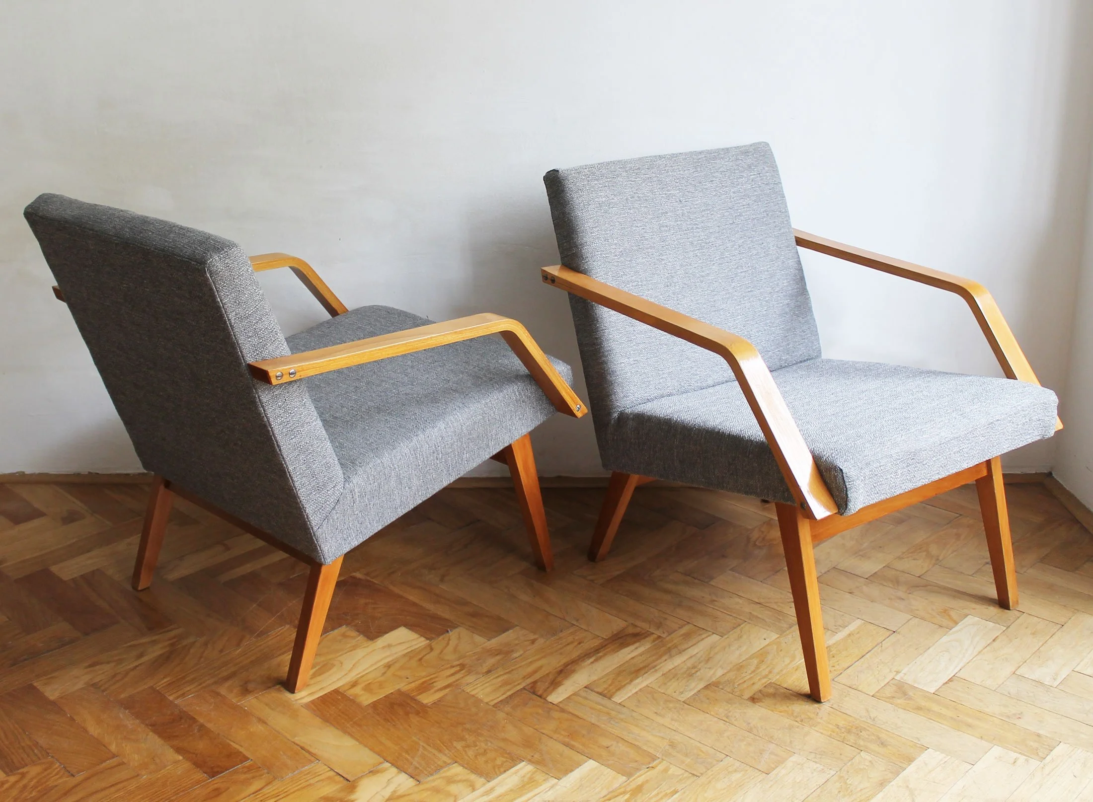 vintage lounge chairs with sculptural wooden armrests.jpg
