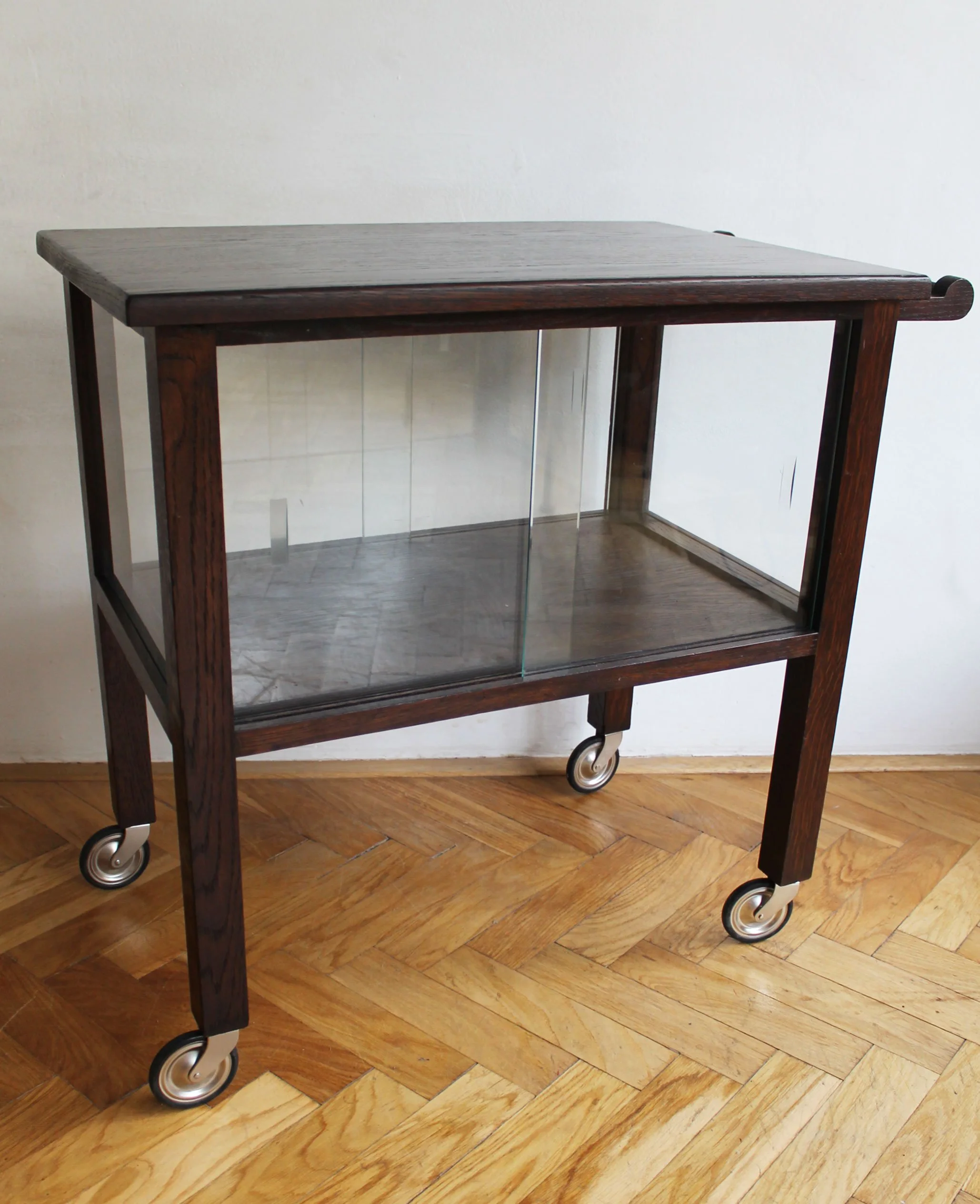 Vintage serving trolley styled as drinks cart with glassware and bottles.jpg