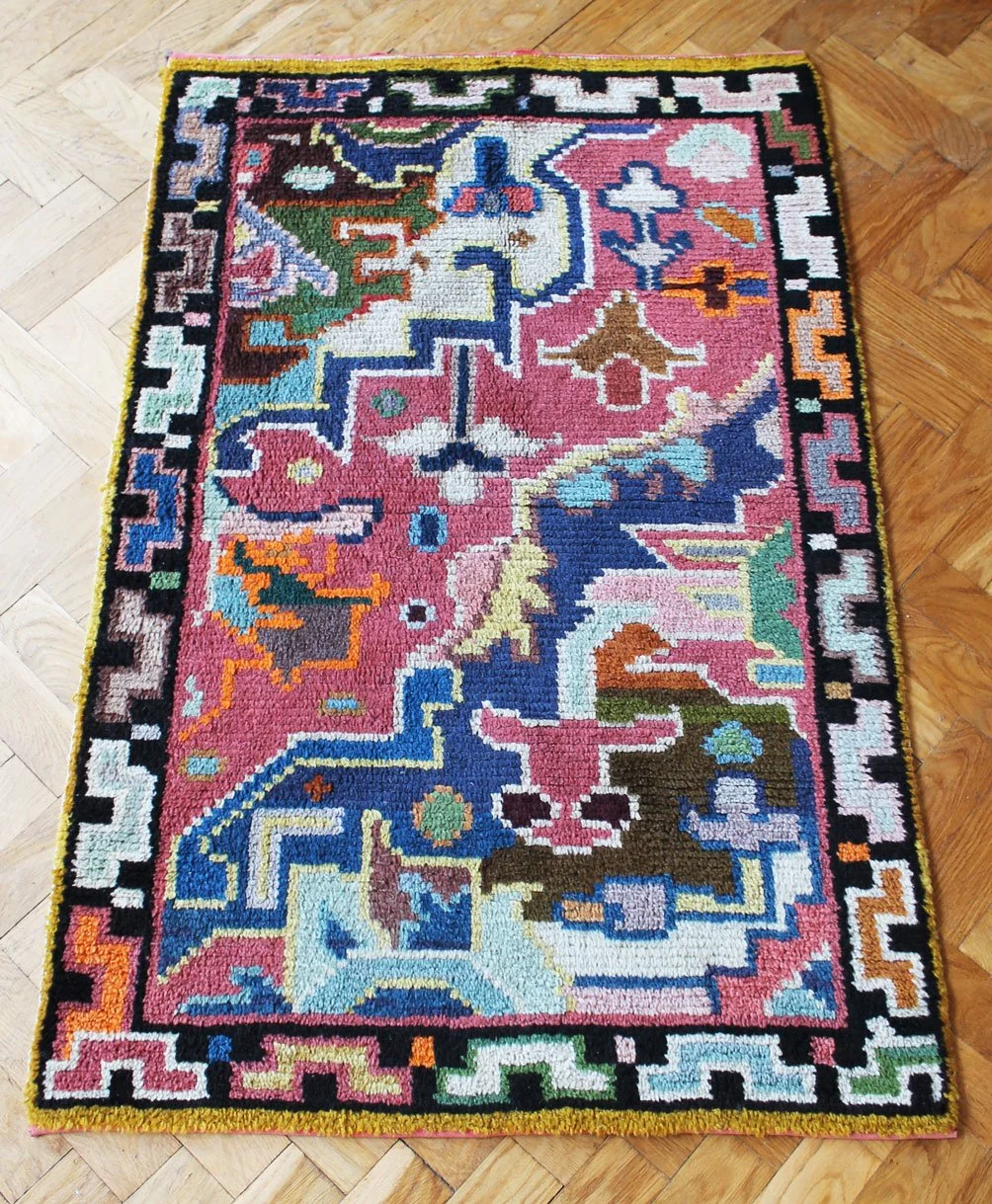 Textured wool rug with mid-century geometric patterning.jpg