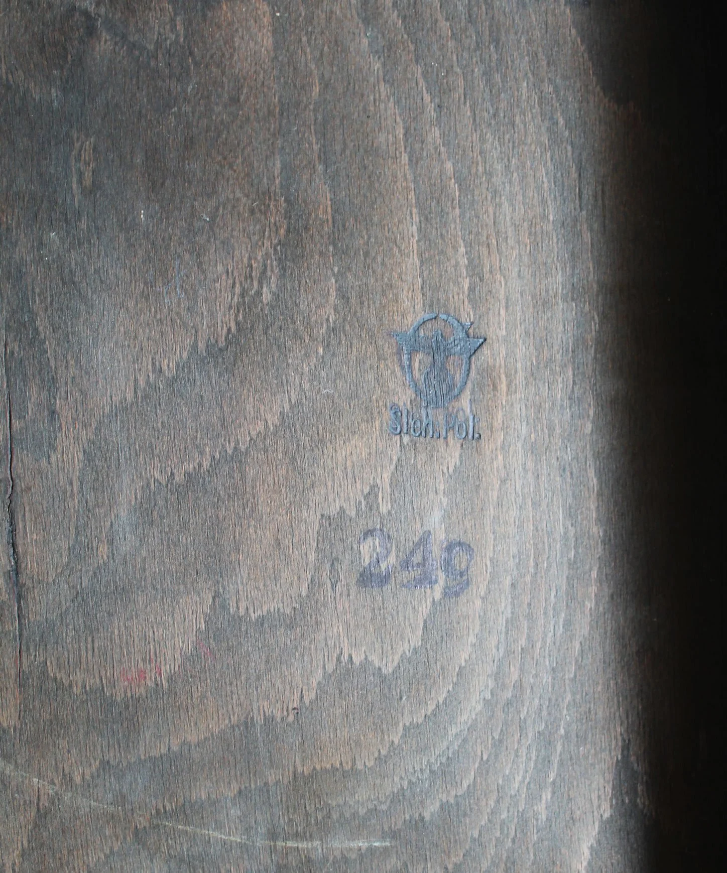 Historic Sicherheitspolizei ownership mark burned into the underside of the wooden chair