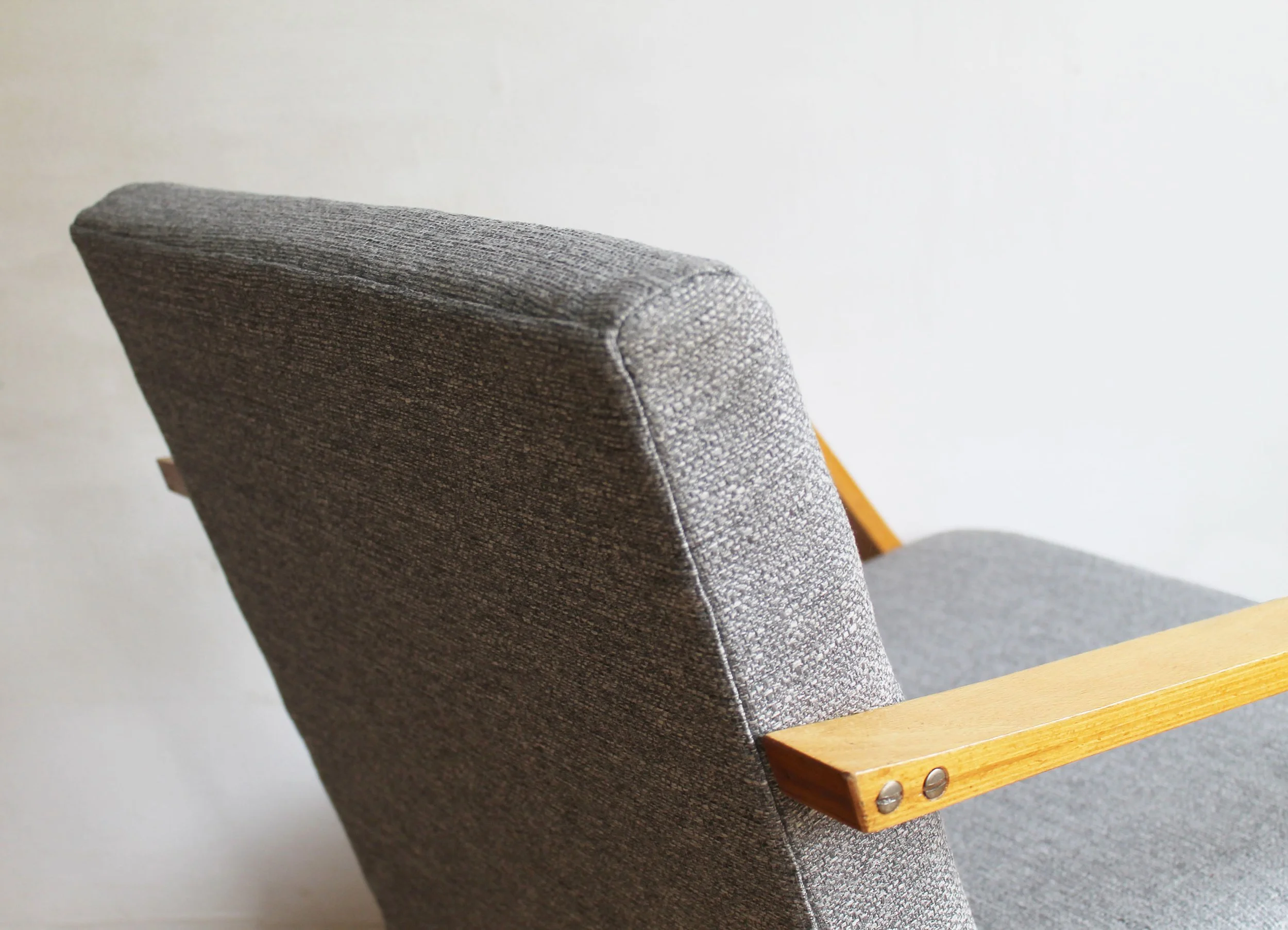 elegant retro armchairs with dynamic armrest design.jpg