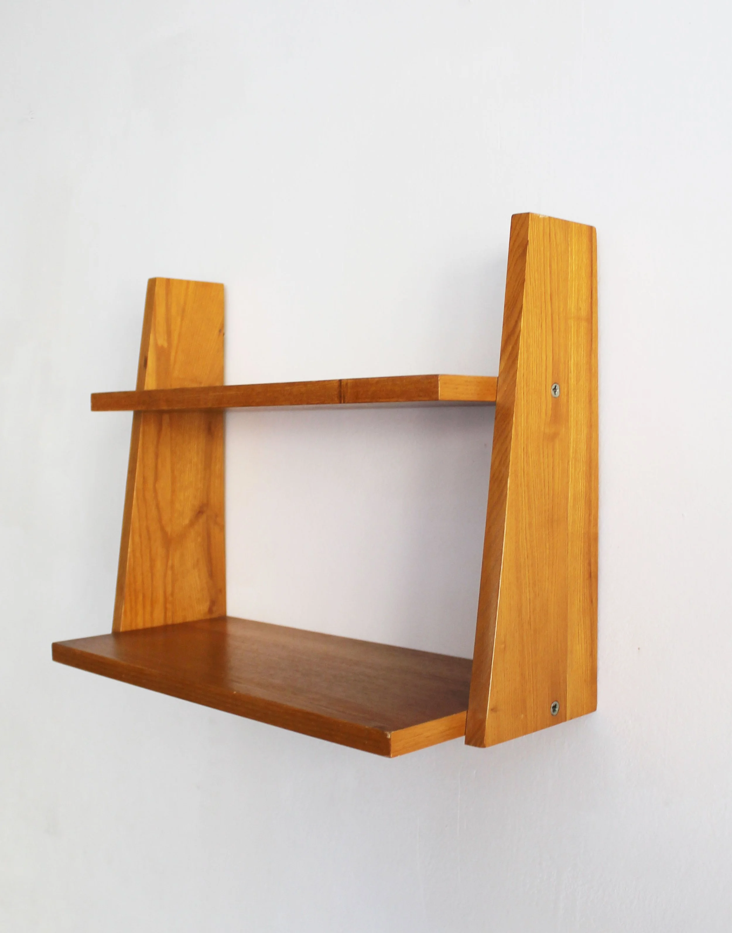 Vintage 1960s Czechoslovak wooden wall shelf mounted against a white wall