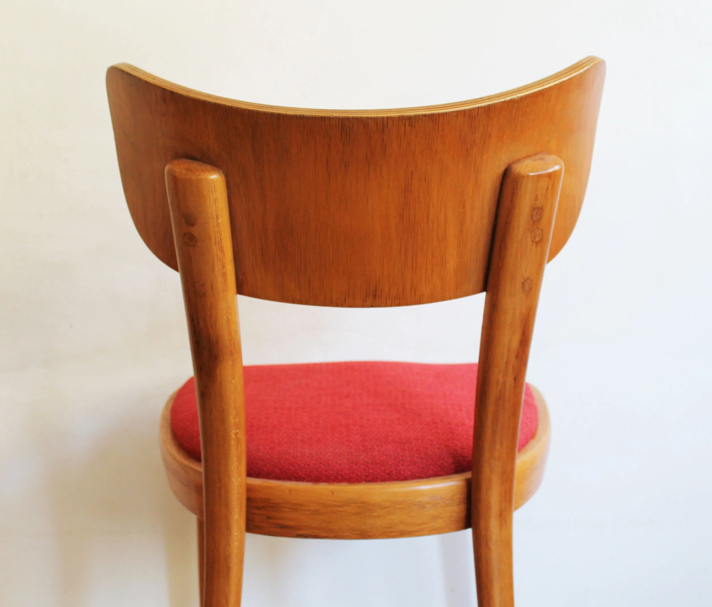 Stackable vintage Thonet chairs with red cushions.jpg