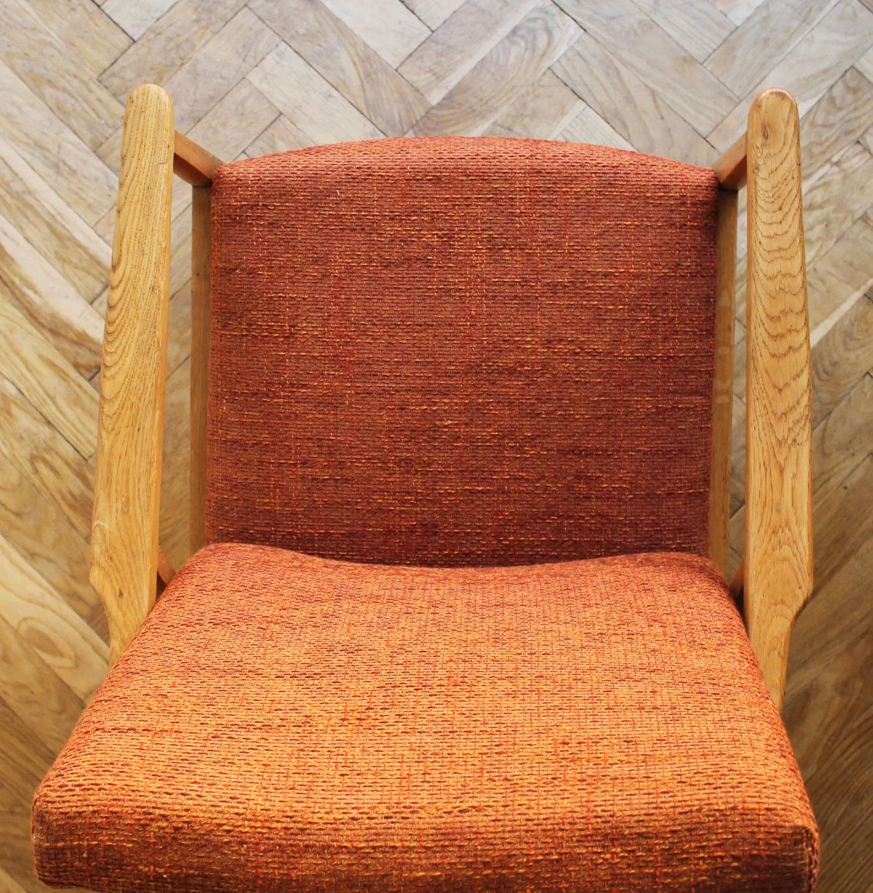 Top-down view of padded seat and wooden frame of vintage armchair.jpg