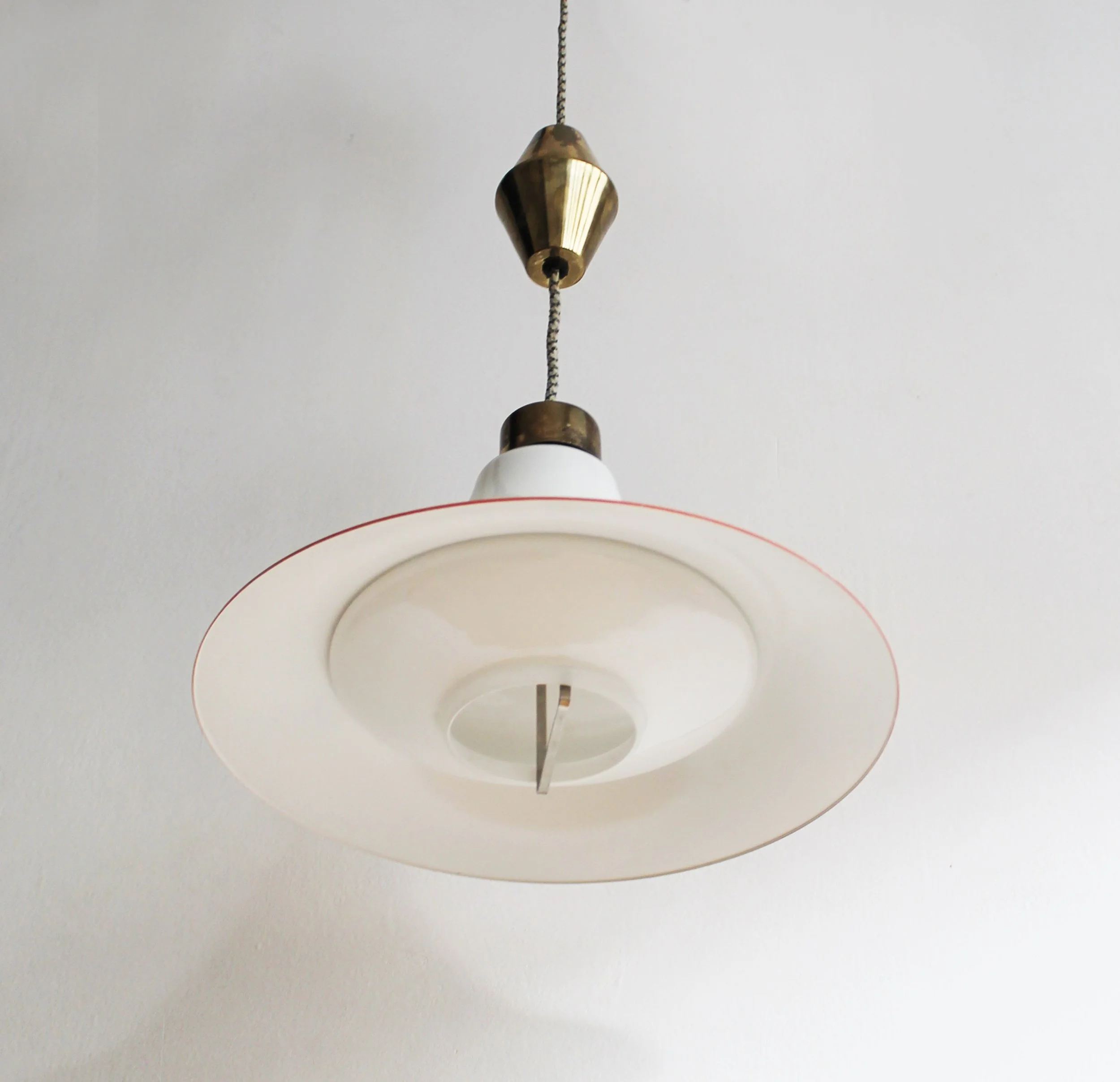 Milky glass shade glowing in warm light, mid-century ceiling lamp.jpg