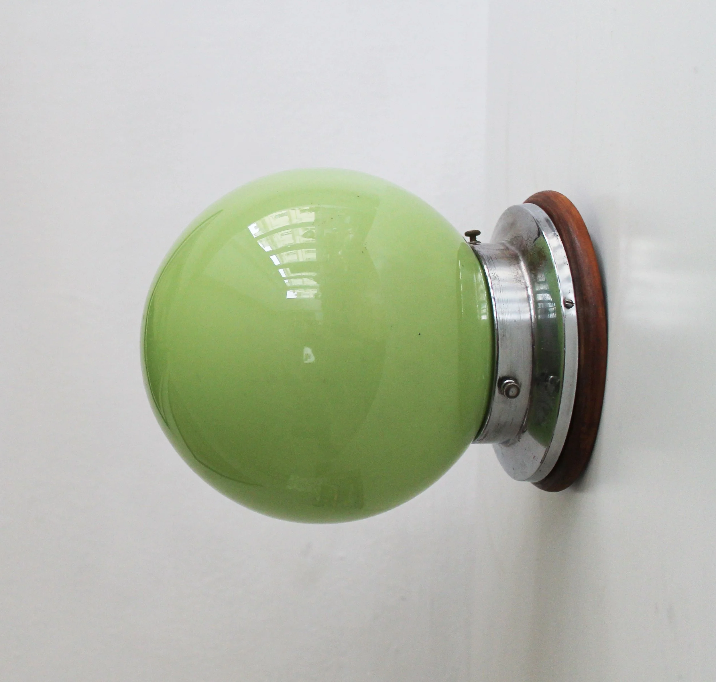 Vintage functionalist wall lamp with green milk-glass globe and chrome steel body.jpg