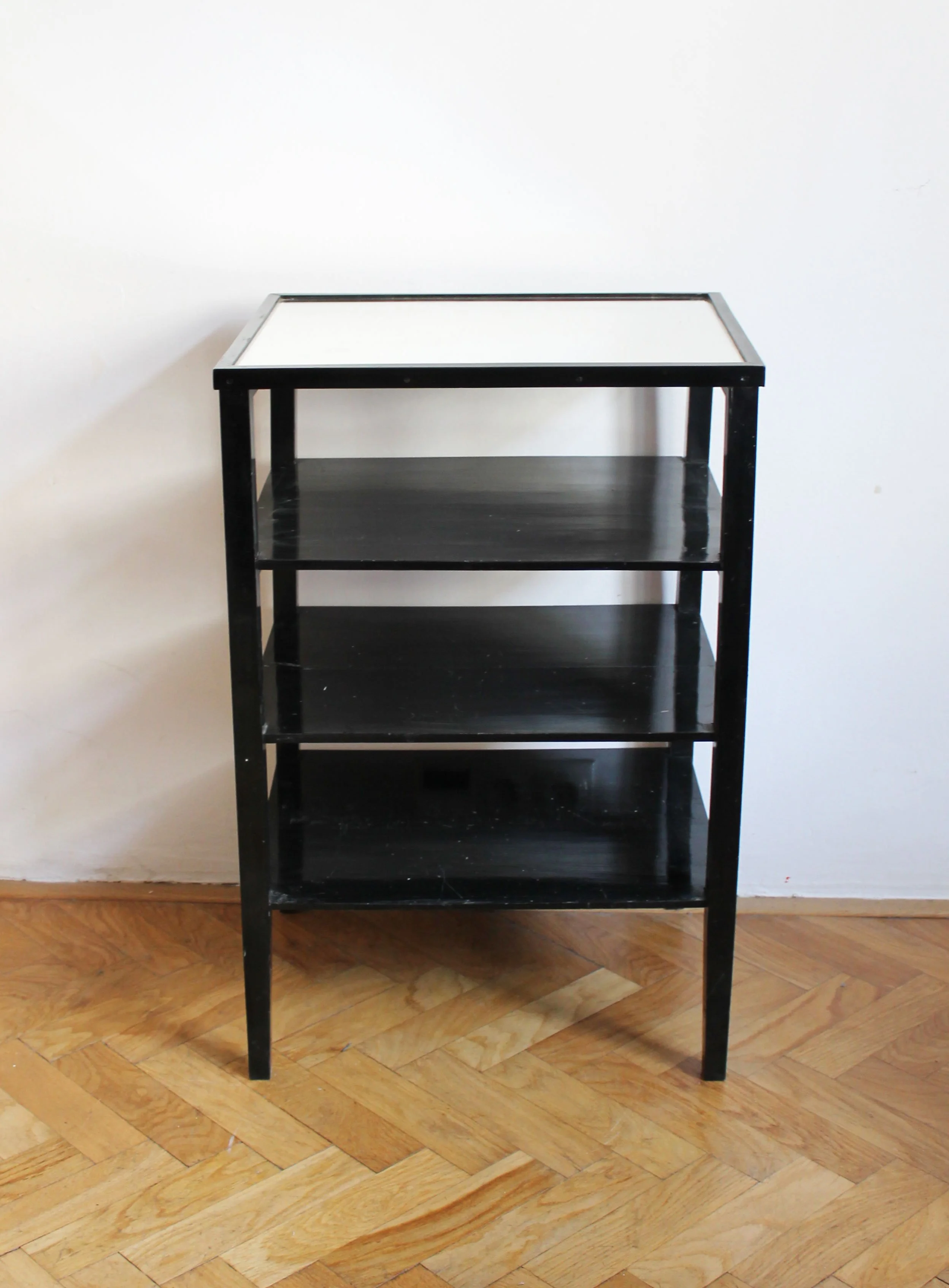 Black-painted 1940s Czechoslovak display stand with three shelves and inset bevelled glass top.jpg