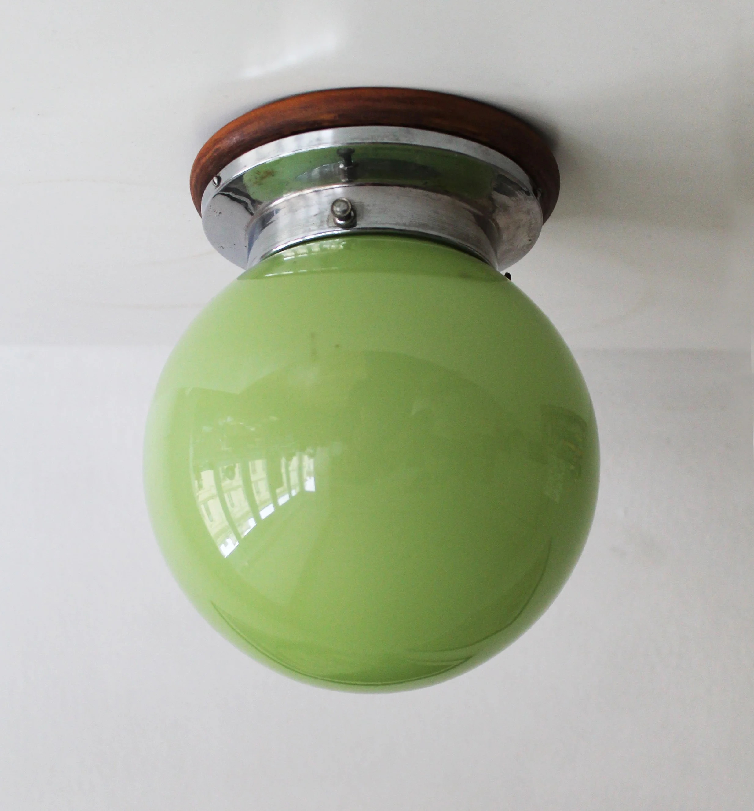 Original 1930s Brno villa light fixture with spherical glass shade and exposed screws.jpg