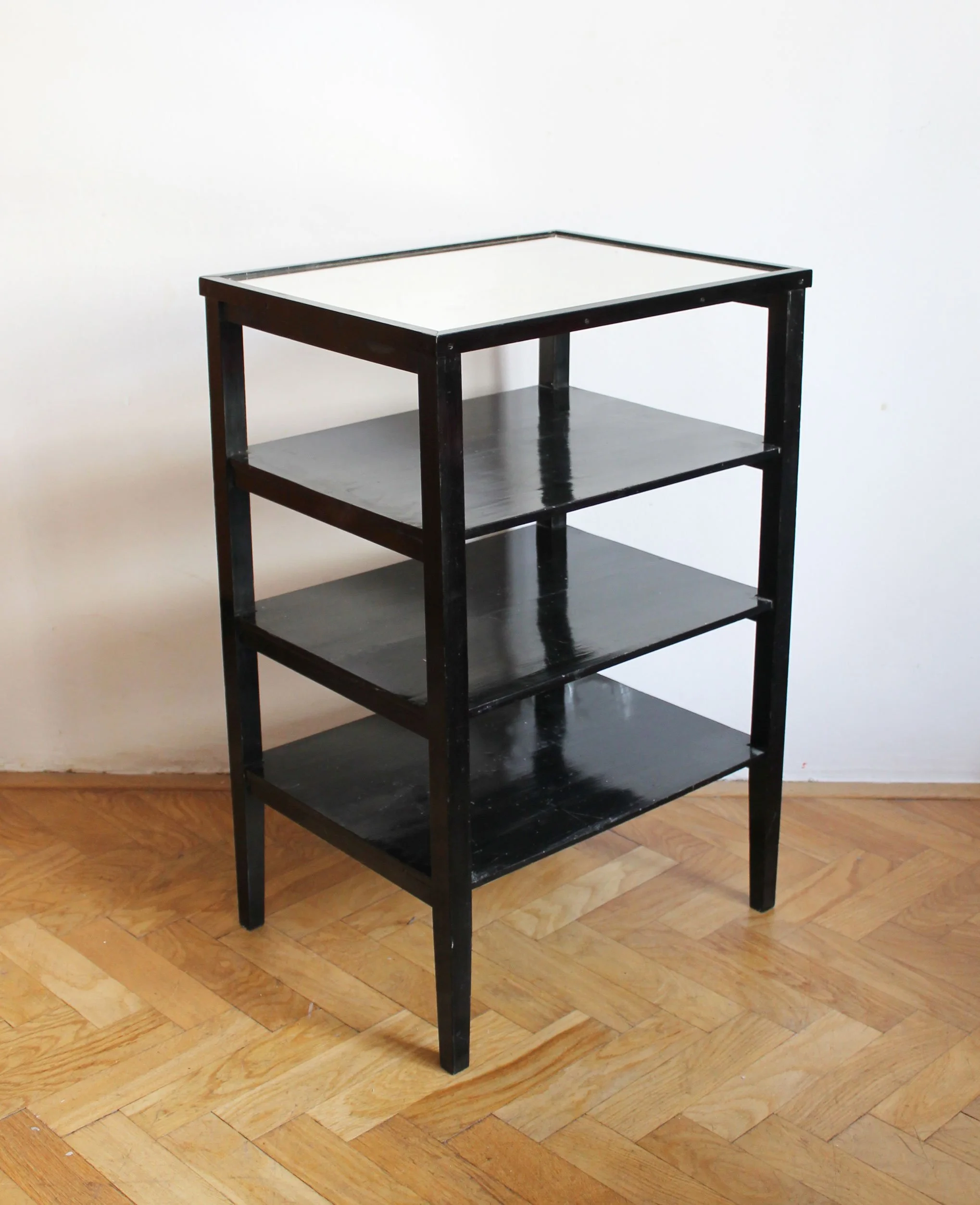Czechoslovak Functionalist étagère from the late 1940s shown from the front with black-painted wood shelves.jpg