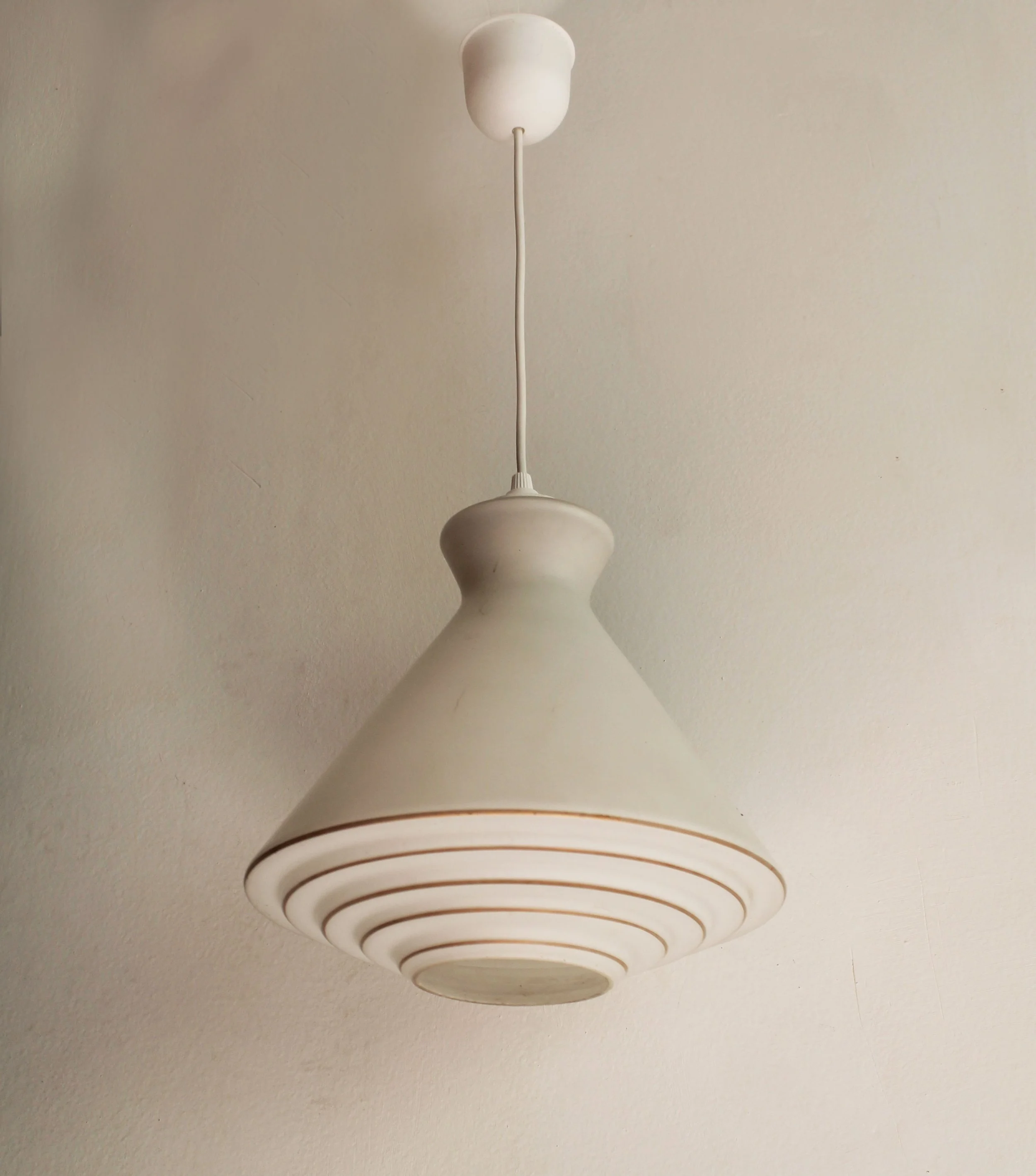 detail of ribbed rings with gold brown lines on lampshade.jpg