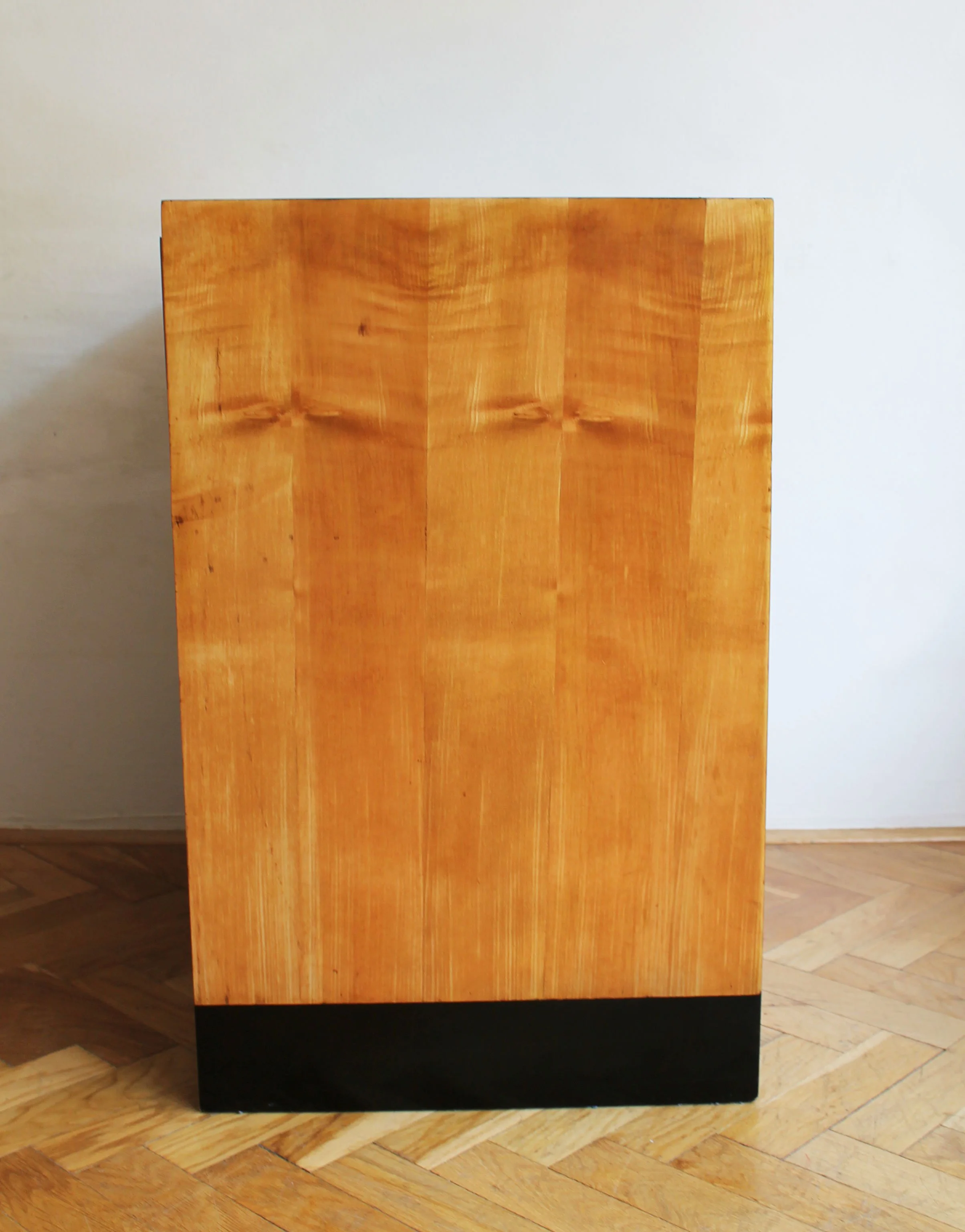 Full view of the refurbished mid-century dressing table on parquet floor.