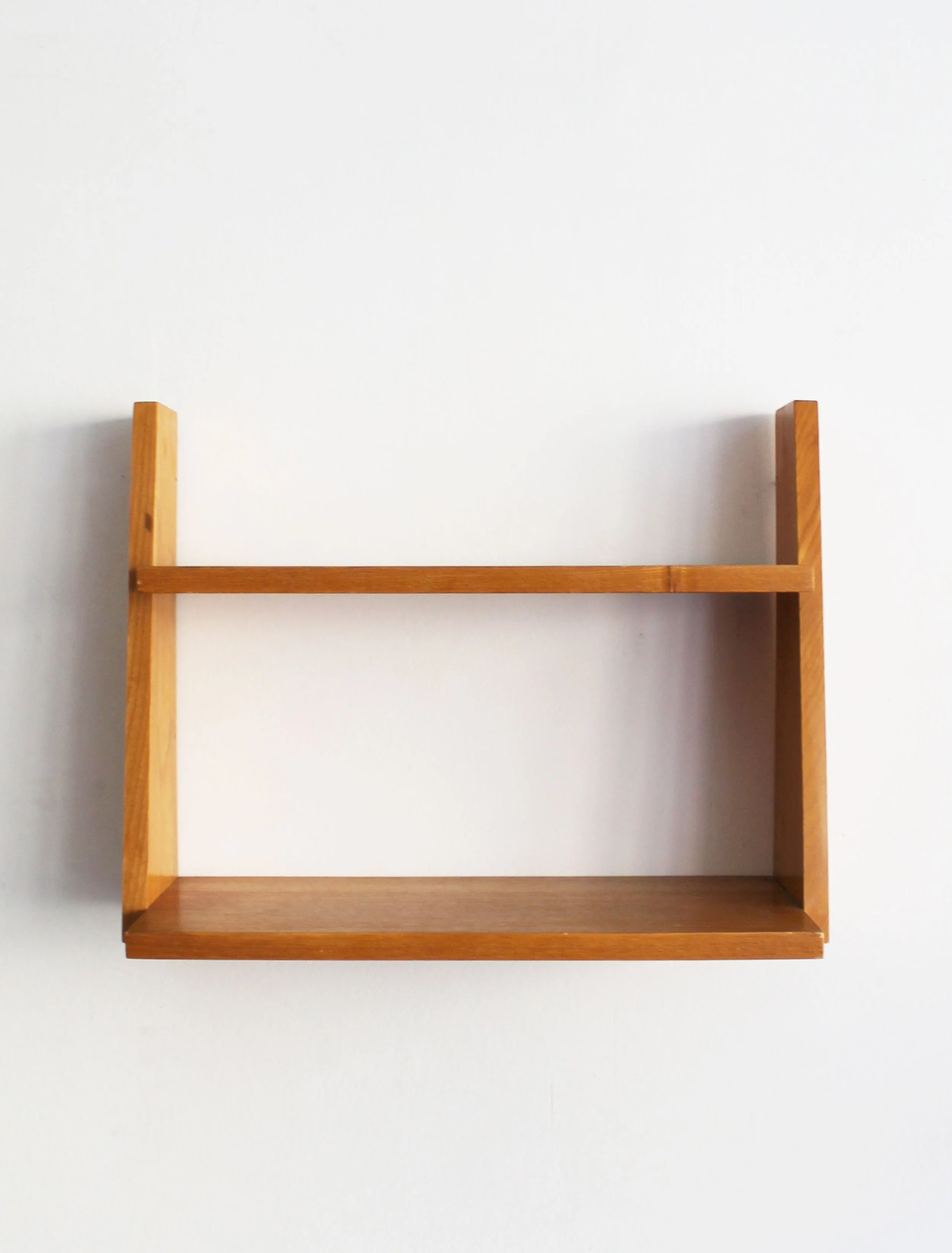 Front view of 1960s Czechoslovak wooden wall shelf with two-tier geometric construction