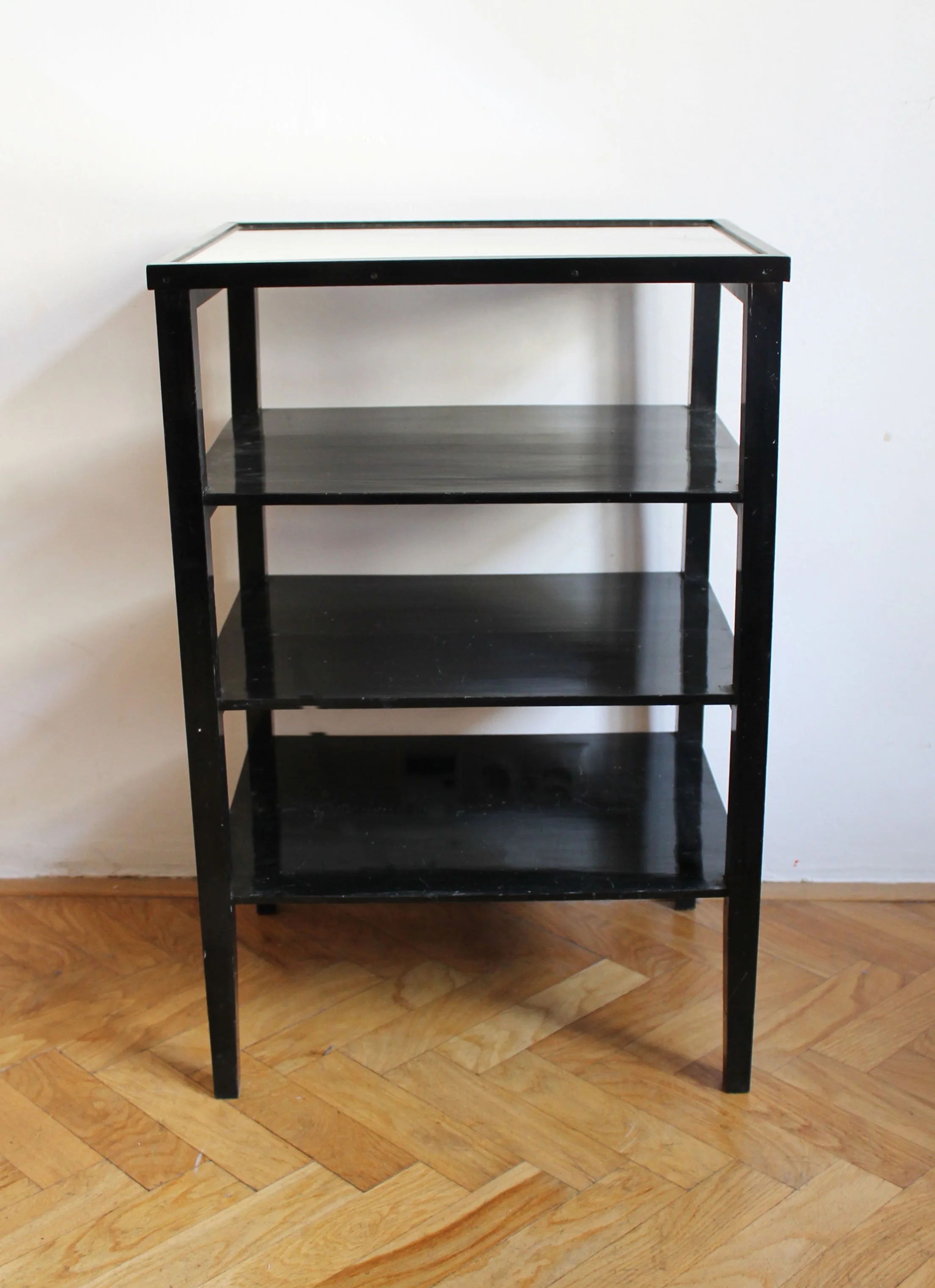 Front elevation of a late 1940s Czechoslovak étagère with three black shelves and glass top.jpg