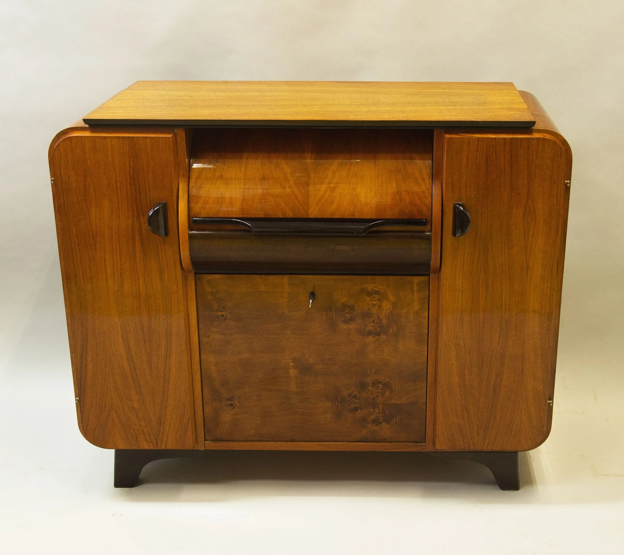 Walnut veneer mid-century cabinet with curved shelves and elegant proportions.jpg