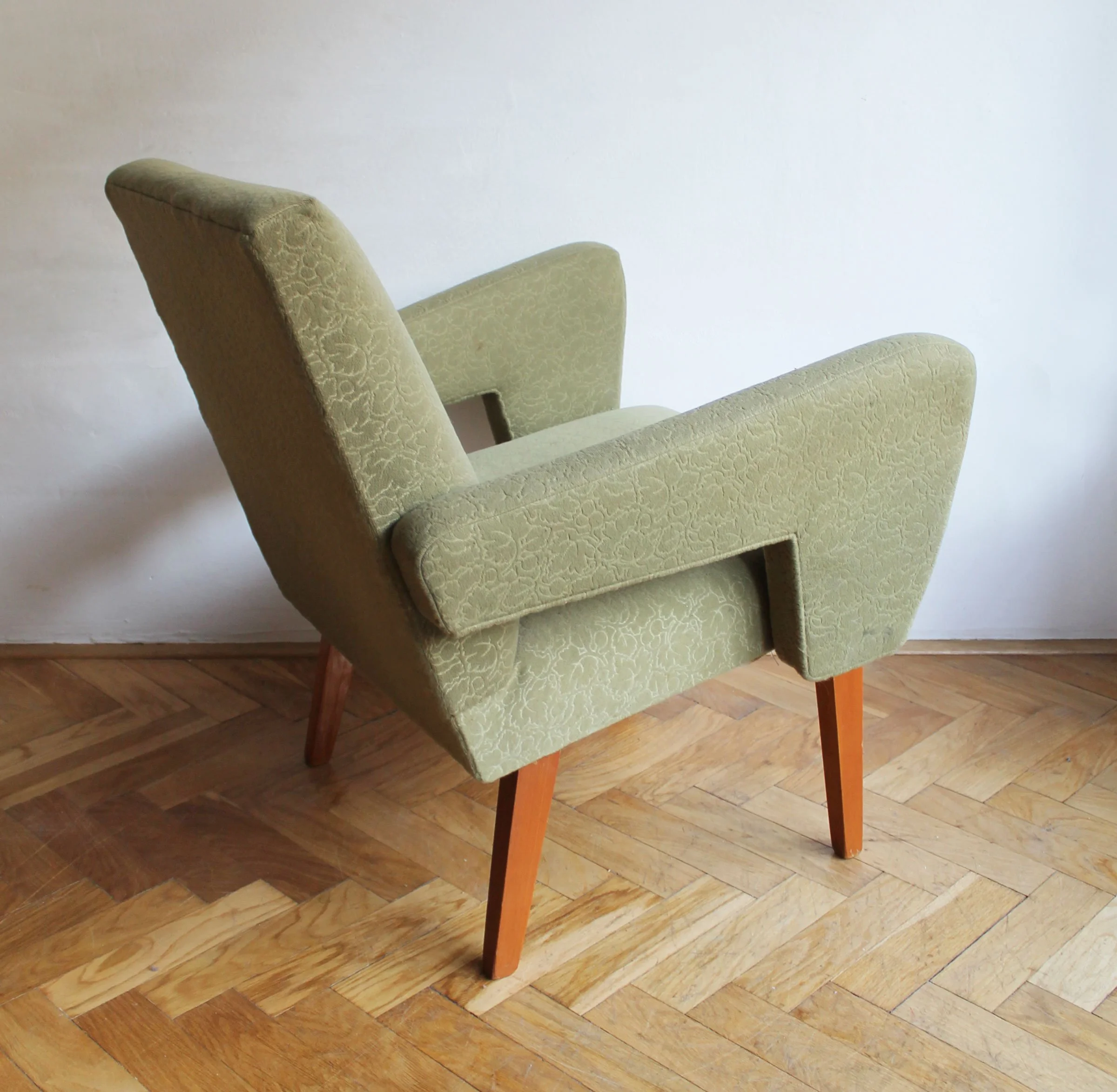 Side view of Czech mid-century armchair with expressive armrest.jpg
