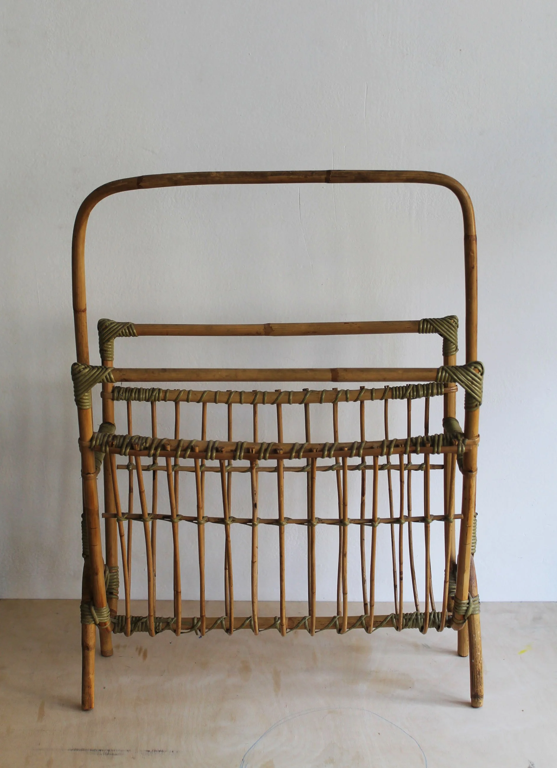 Detail of tall bent-cane handle and hand-wrapped green joints on 1960s Czechoslovak magazine rack