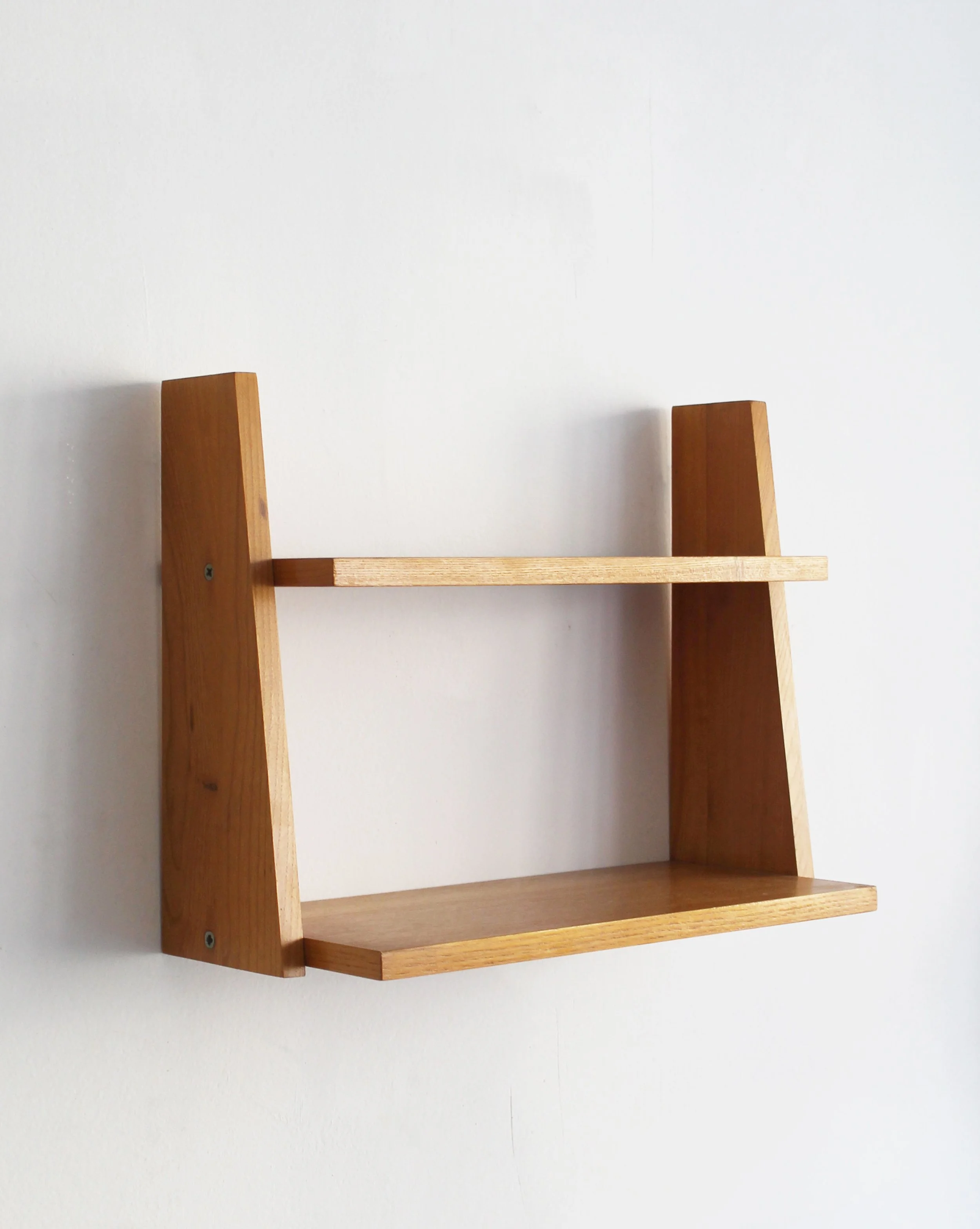 Angled rear view of 1960s Czechoslovak wall shelf showing beech sides and mounting points