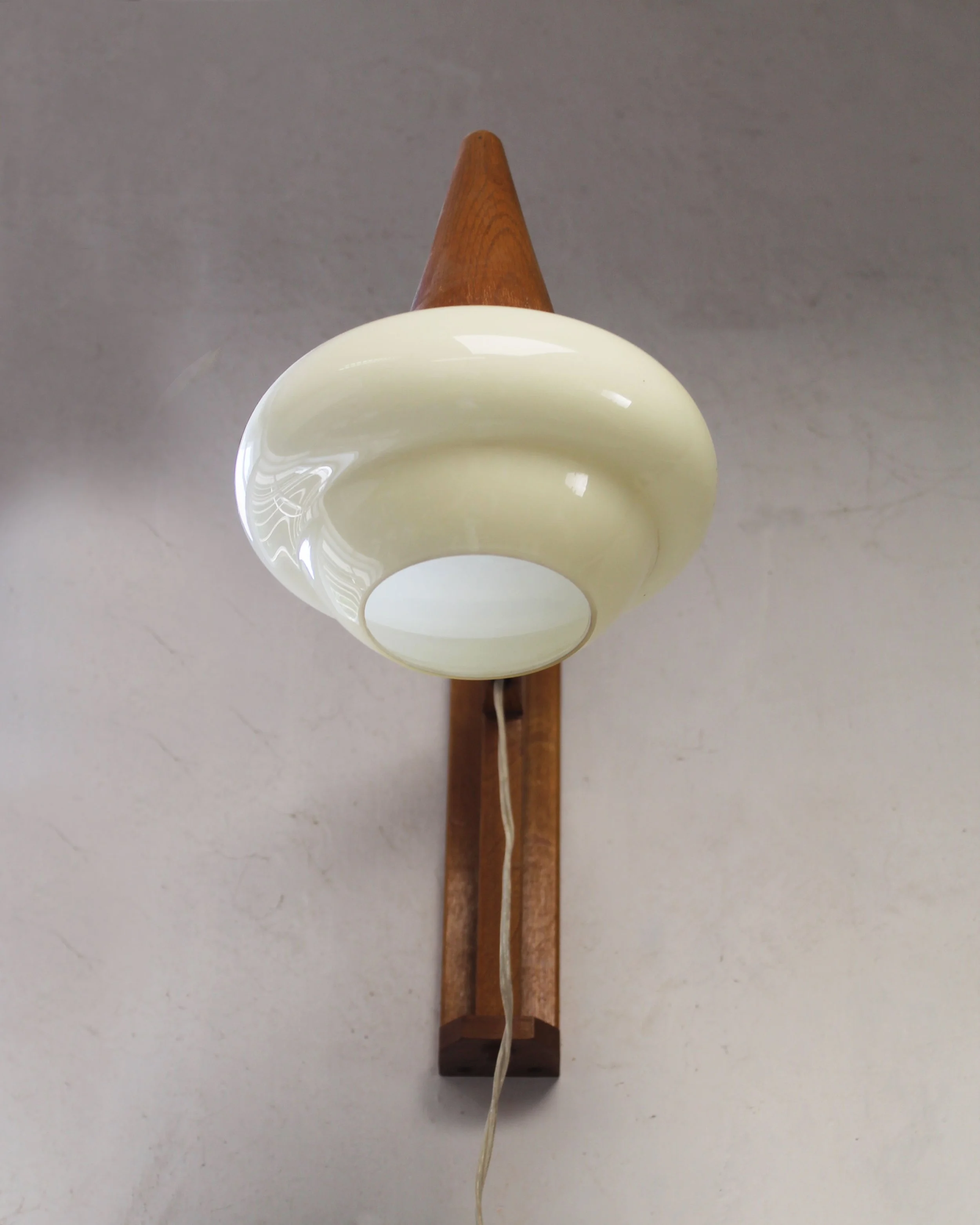 Side view of the opaline glass shade, wooden arm and sculpted wall plate.jpg