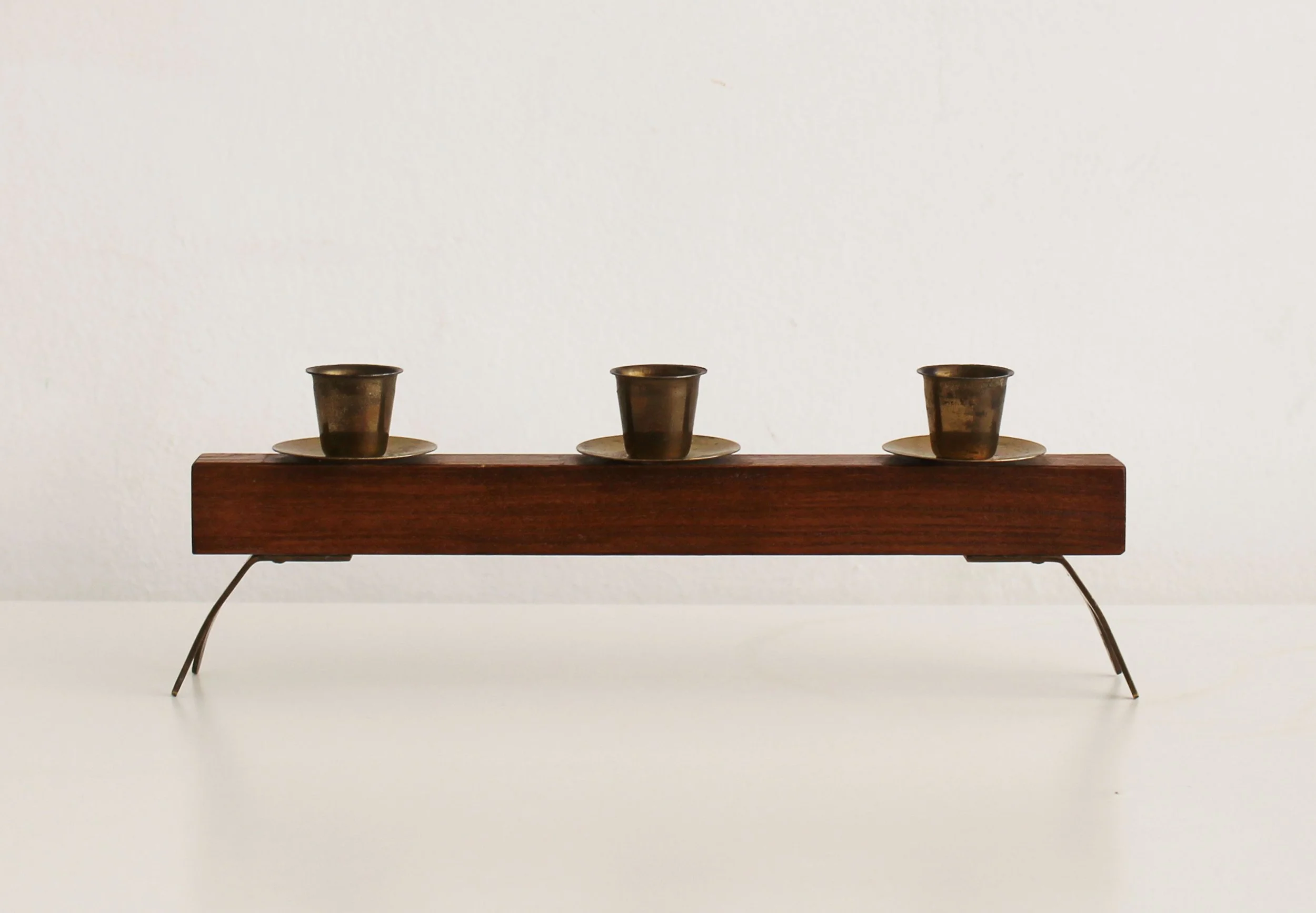 Side profile of 1960s Czechoslovak candleholder with metal support legs