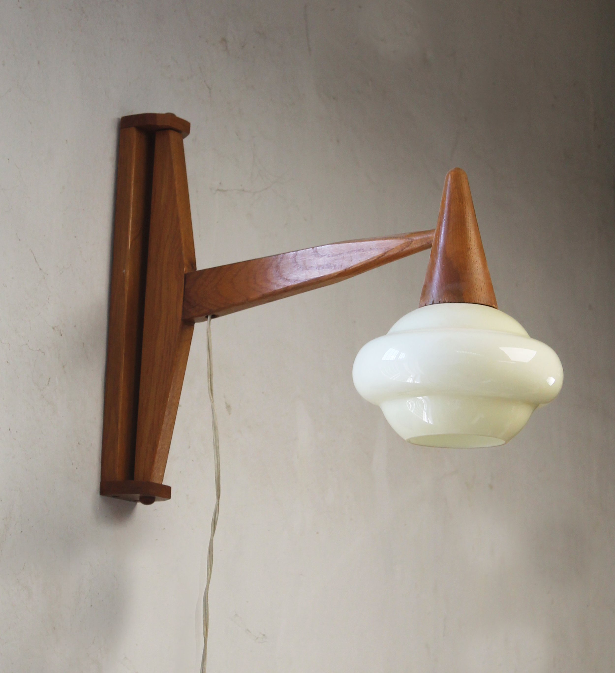 Scandinavian-inspired wooden wall lamp with adjustable cantilevered arm.jpg