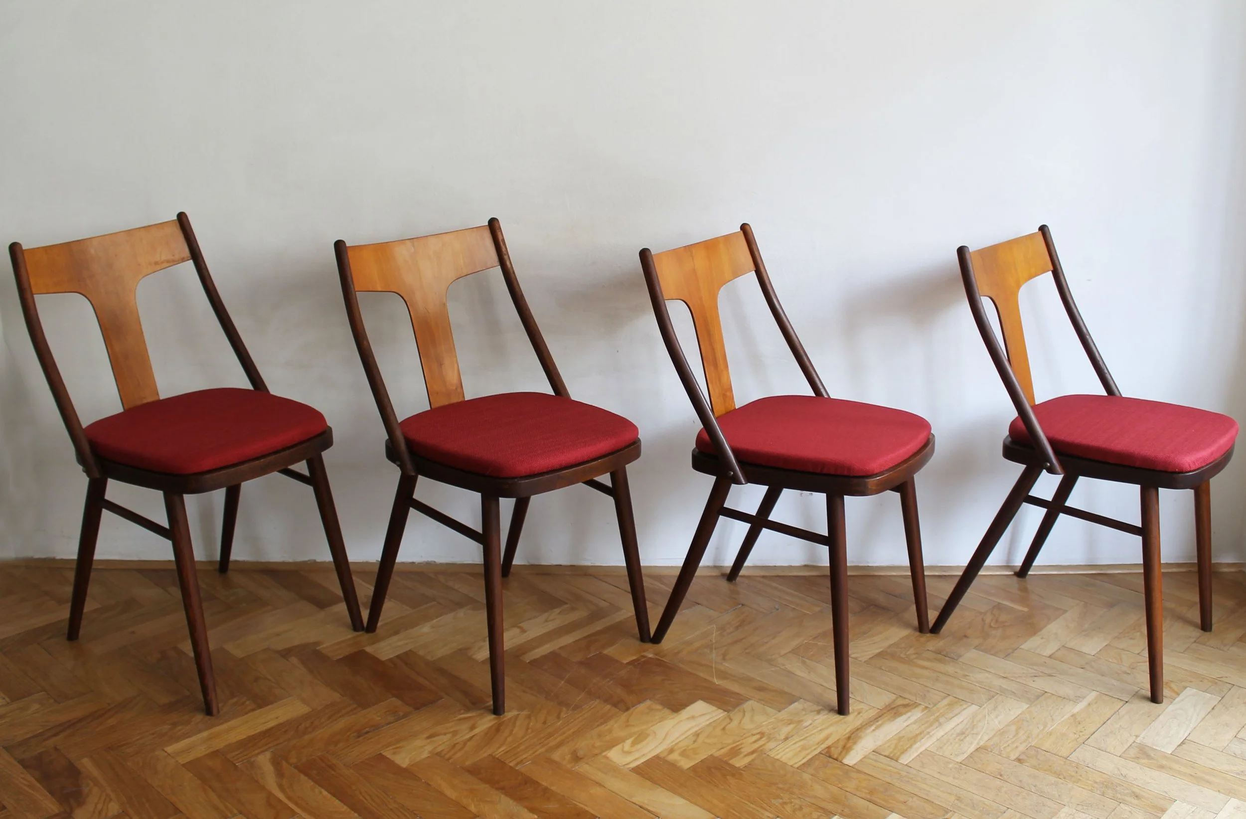 Mid-century Czech dining chairs with red upholstered seats.jpg