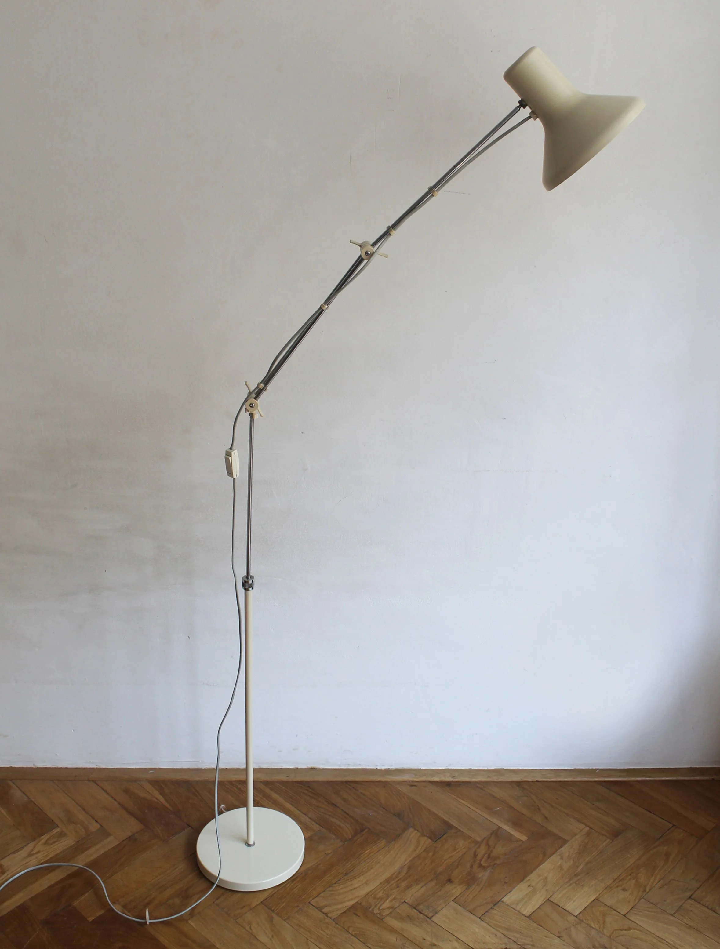 Floor-level shot showing round metal base and upright pole