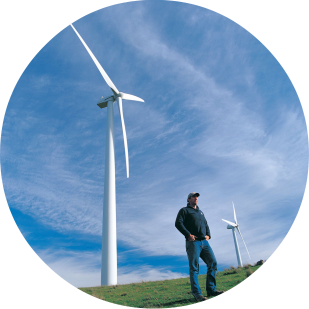 Wind farm and farmer, by image library, cc..png
