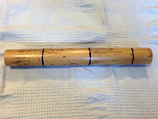 Tube cane with marks corresponding to the center and ends of the template