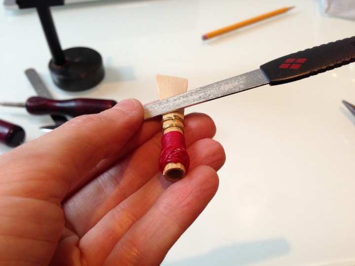 Positioning the file flat against the blade