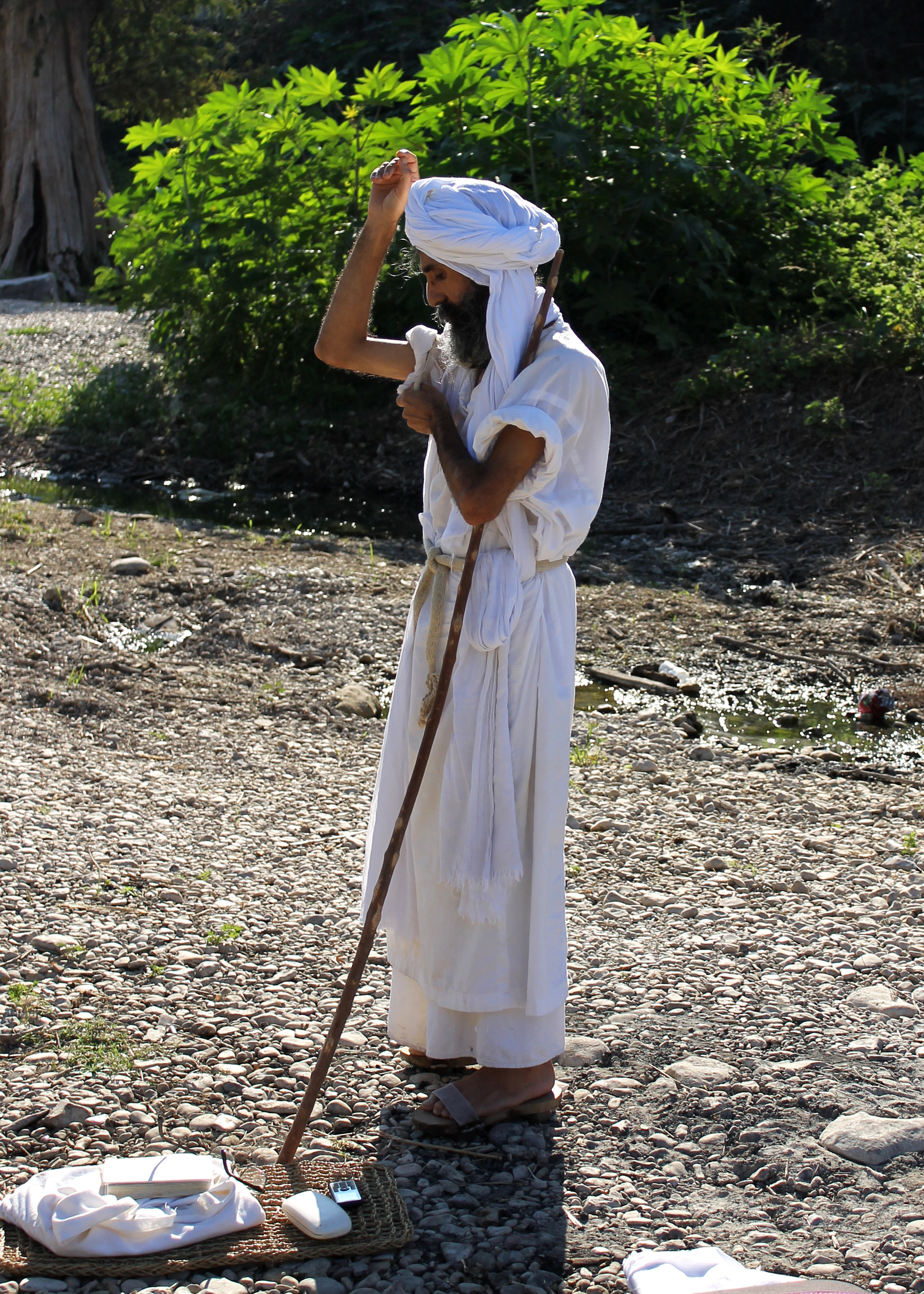 Basam Fazel, the religious leader for the Mandean community living in Texas, prepares for a baptism ceremony on Saturday, Sept. 26. As part of the preparations for the ceremony he asks the river permission to enter it. 