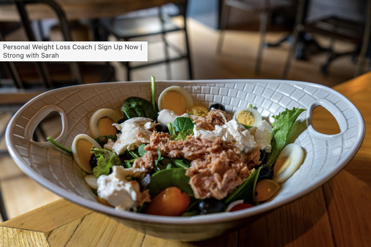 a plate of high-protein lunch with tuna, eggs, and cherry tomatoes